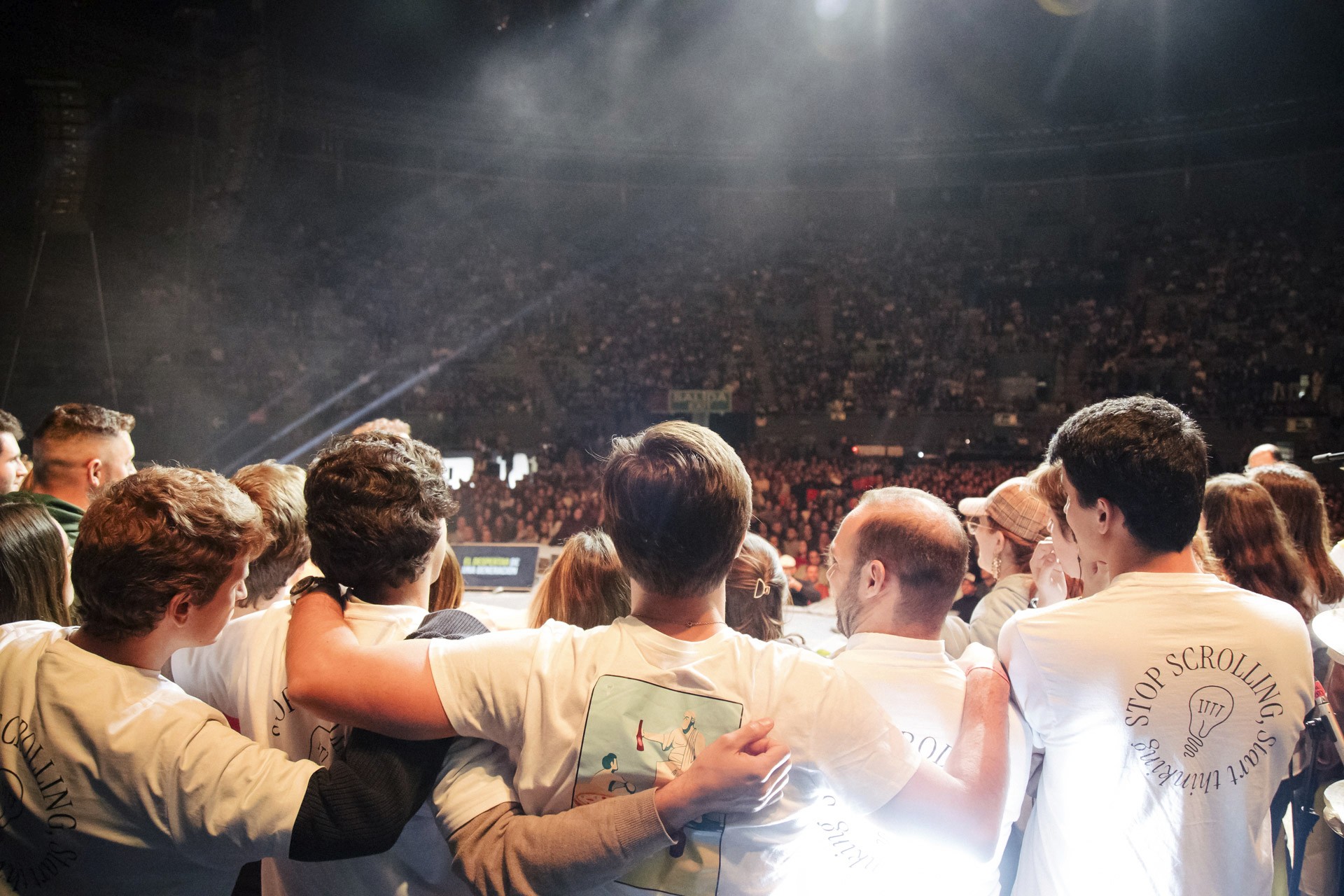 4 students looking at a glowing tablet, illustrative