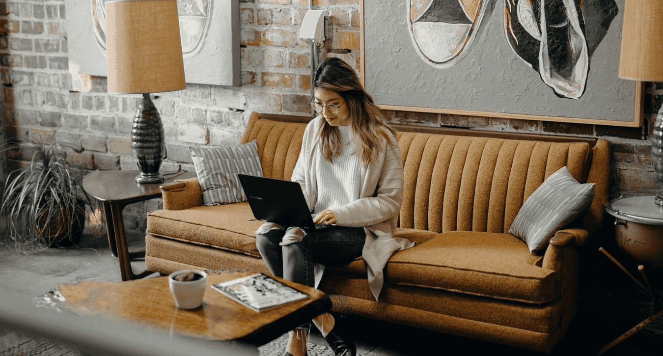 Woman working from couch in coworking space for recruiters highlighting flexible work