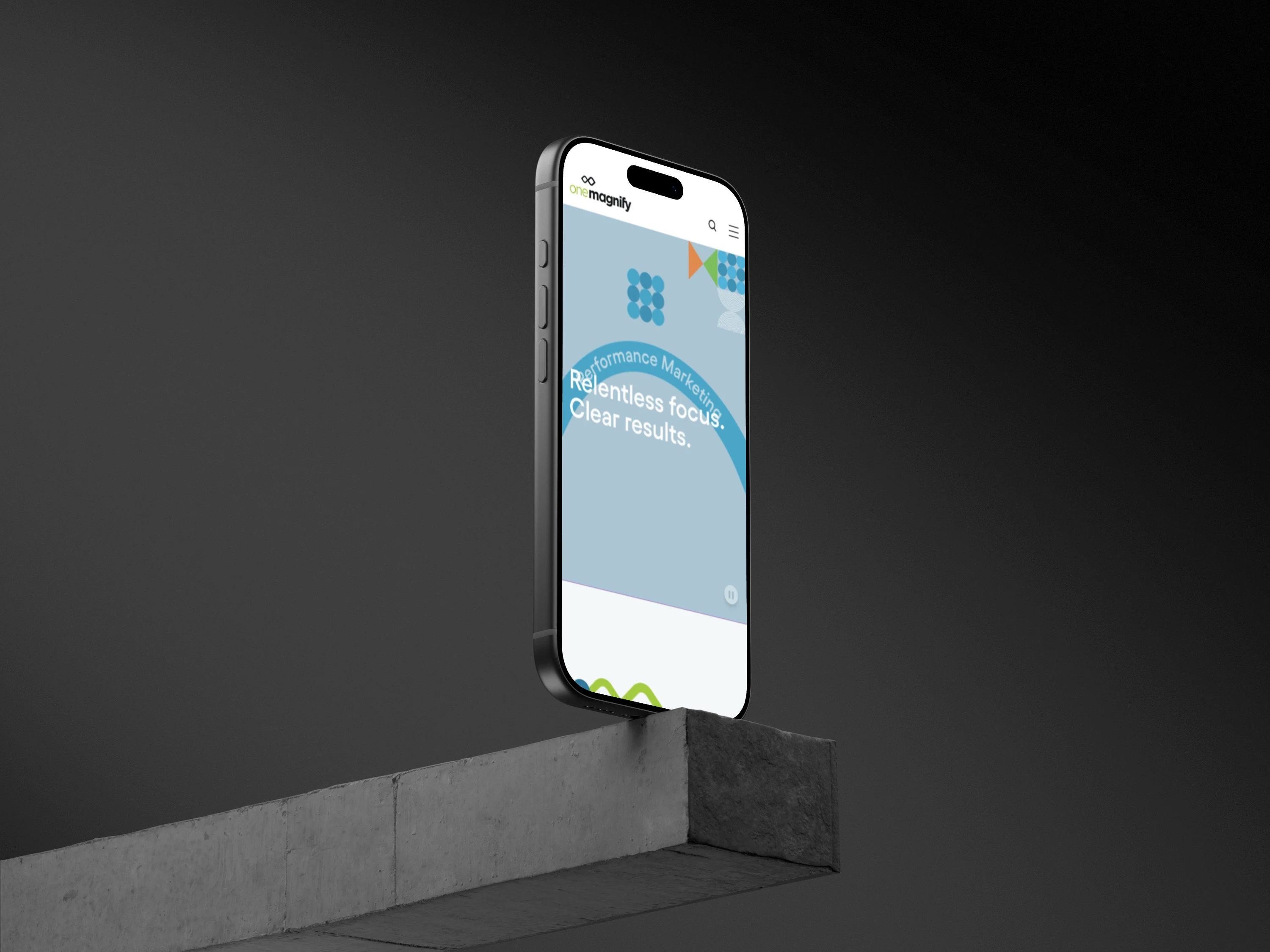 One Magnific website on an iphone standing of a edge a concrete bar slab