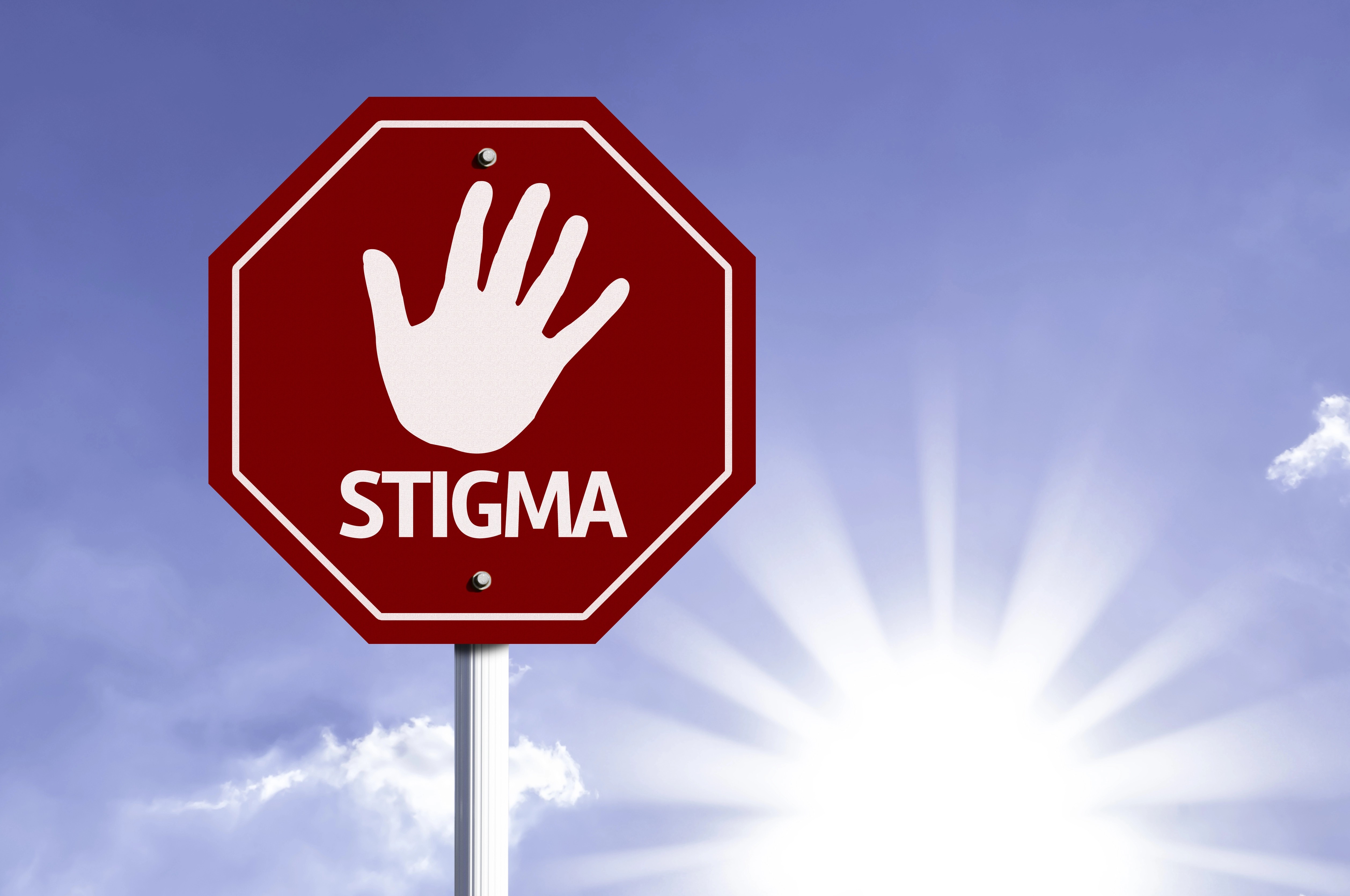 stop sign showing a hand and the word stigma