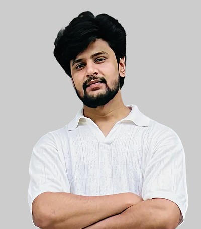 A young man in a white t-shirt stands against a light-colored background.
