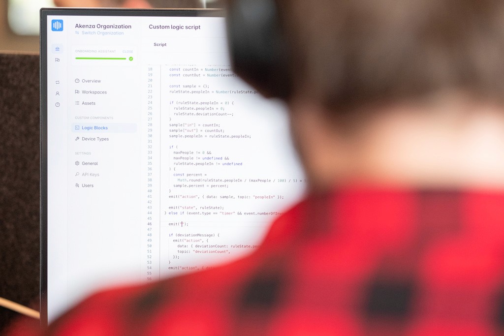 The back of a person looking onto the akenza dashboard