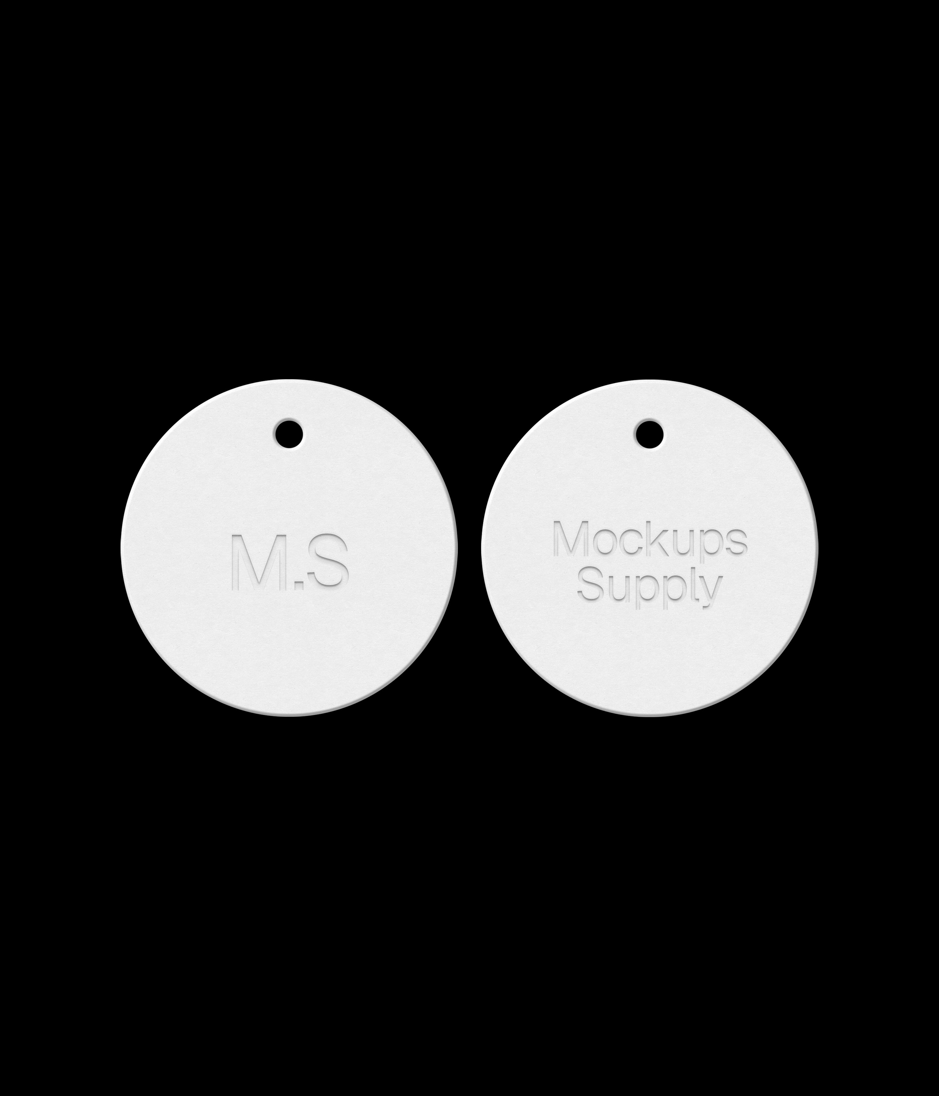 Two white round hang tags on black background showing debossed text effect for photoshop mockup PSD template download