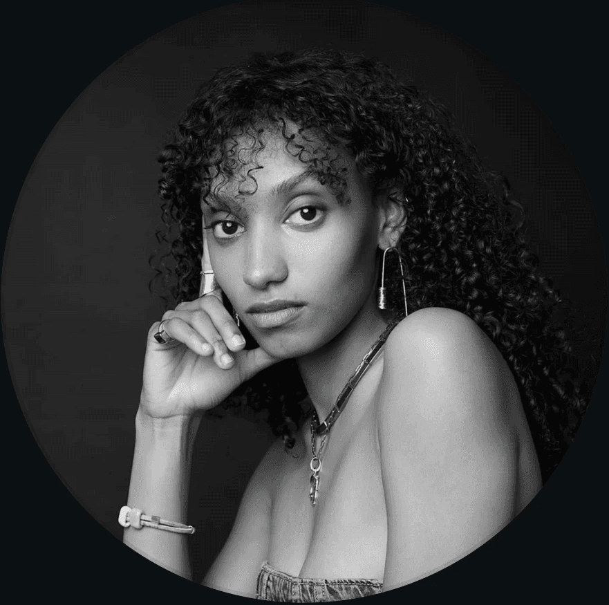 Young man with red hair, freckles, tweed jacket, and silk scarf.