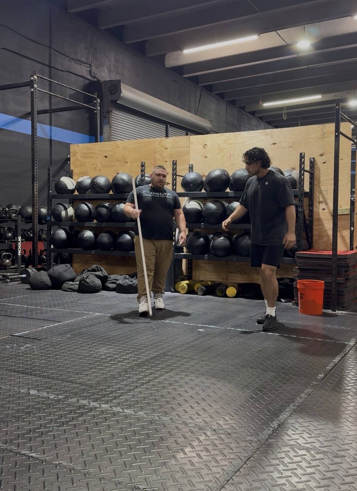 Modern fitness center lined with rows of treadmills and stationary bikes, showcasing a sleek cardio area with Technogym equipment and large windows.