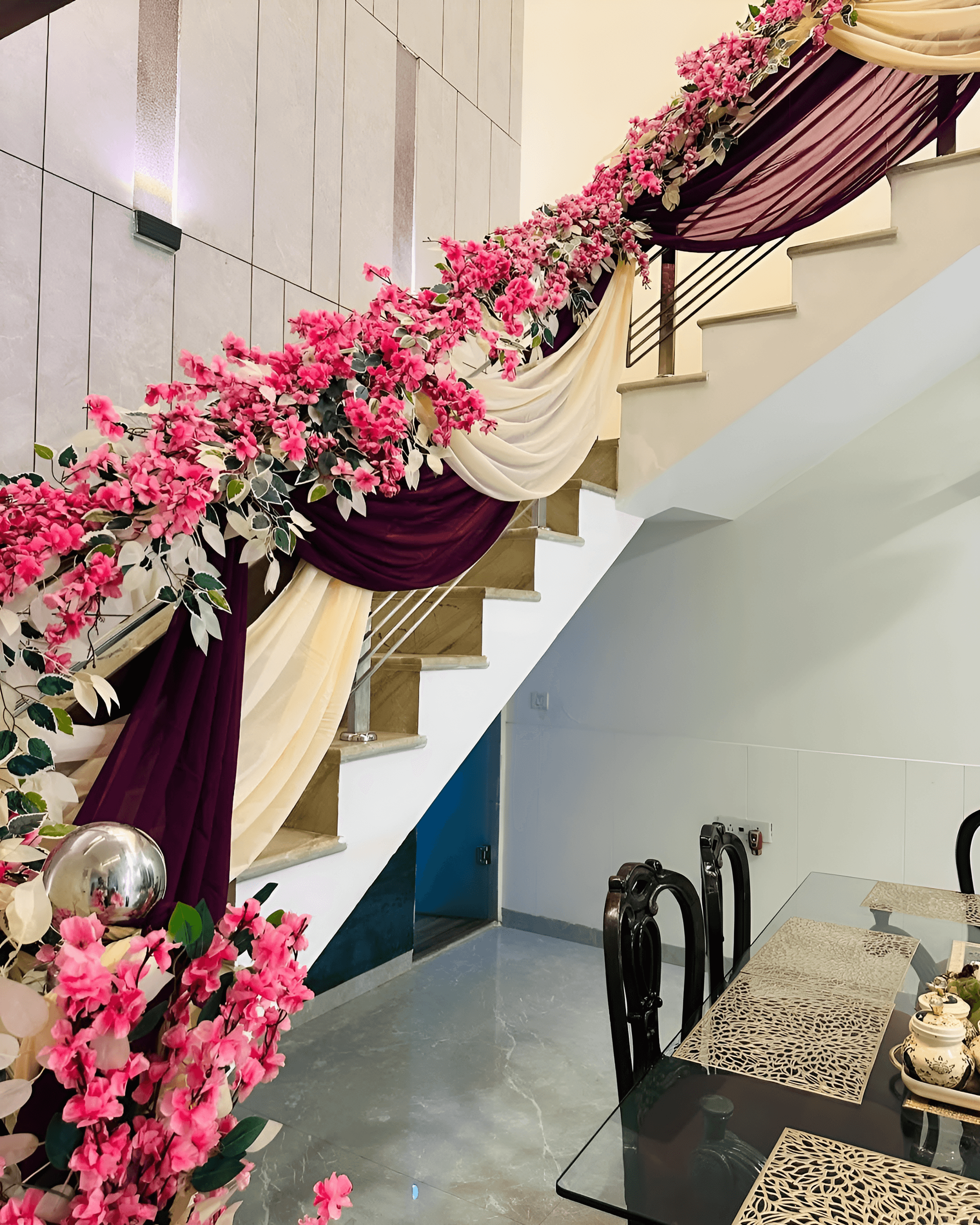 Staircase decoration with pink flowers & maroon cream drapes for wedding home decor near South Delhi, Raj Nagar, Vasundhara