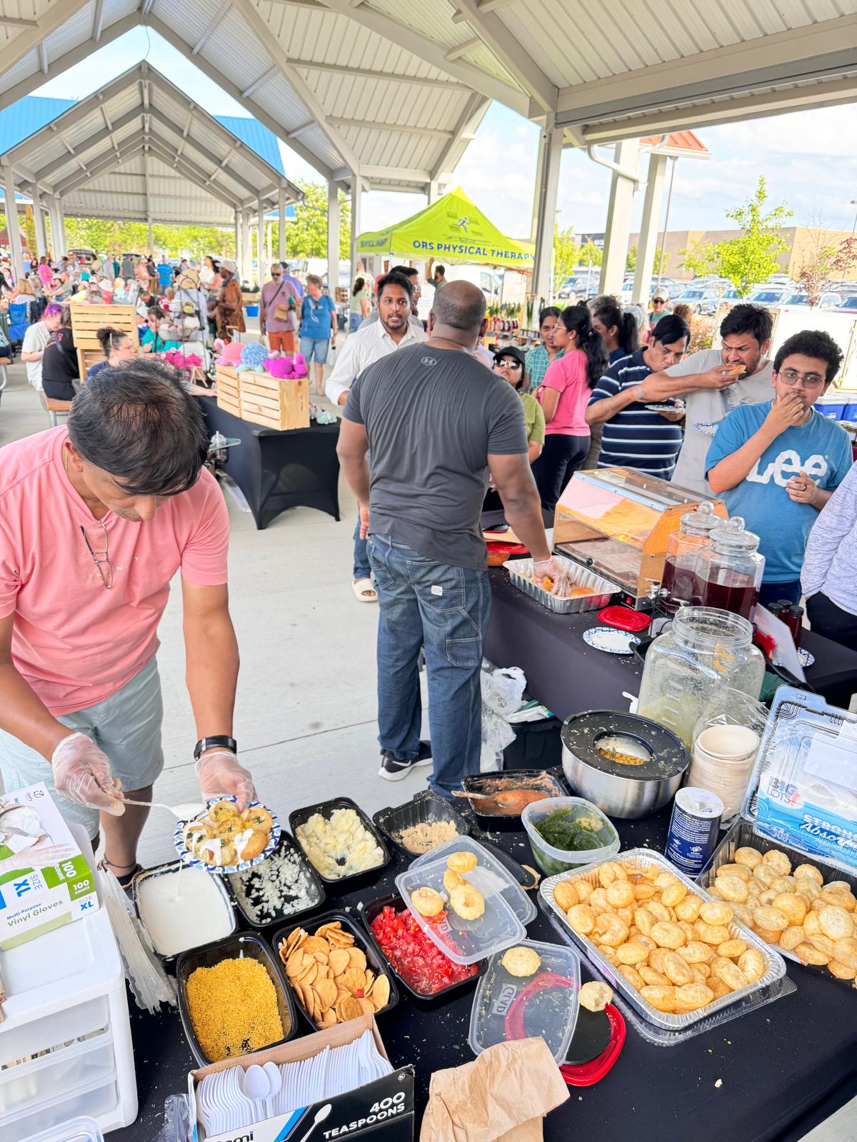 An image of the founder serving food to customers