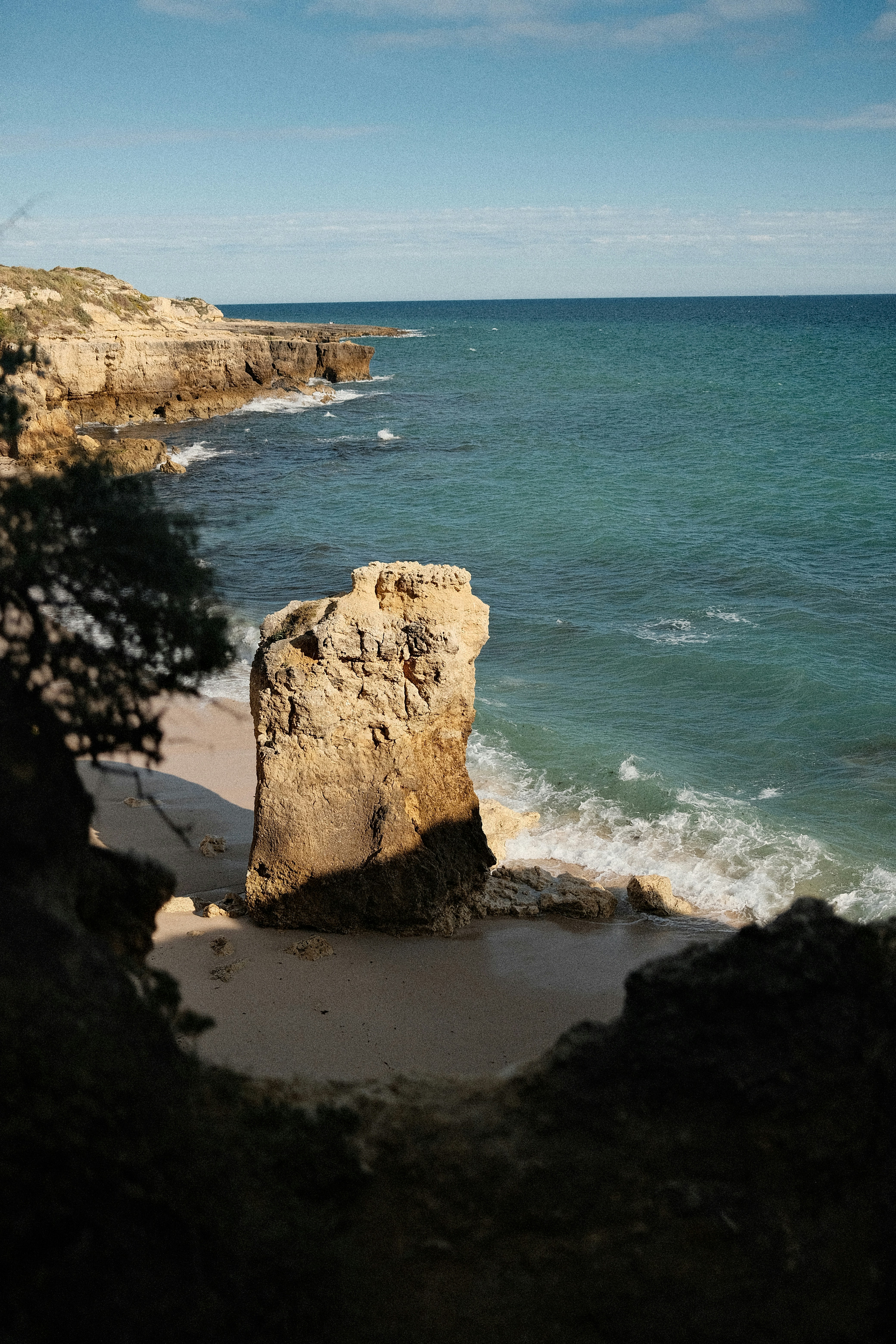 Rocky coastline with turquoise ocean waves crashing