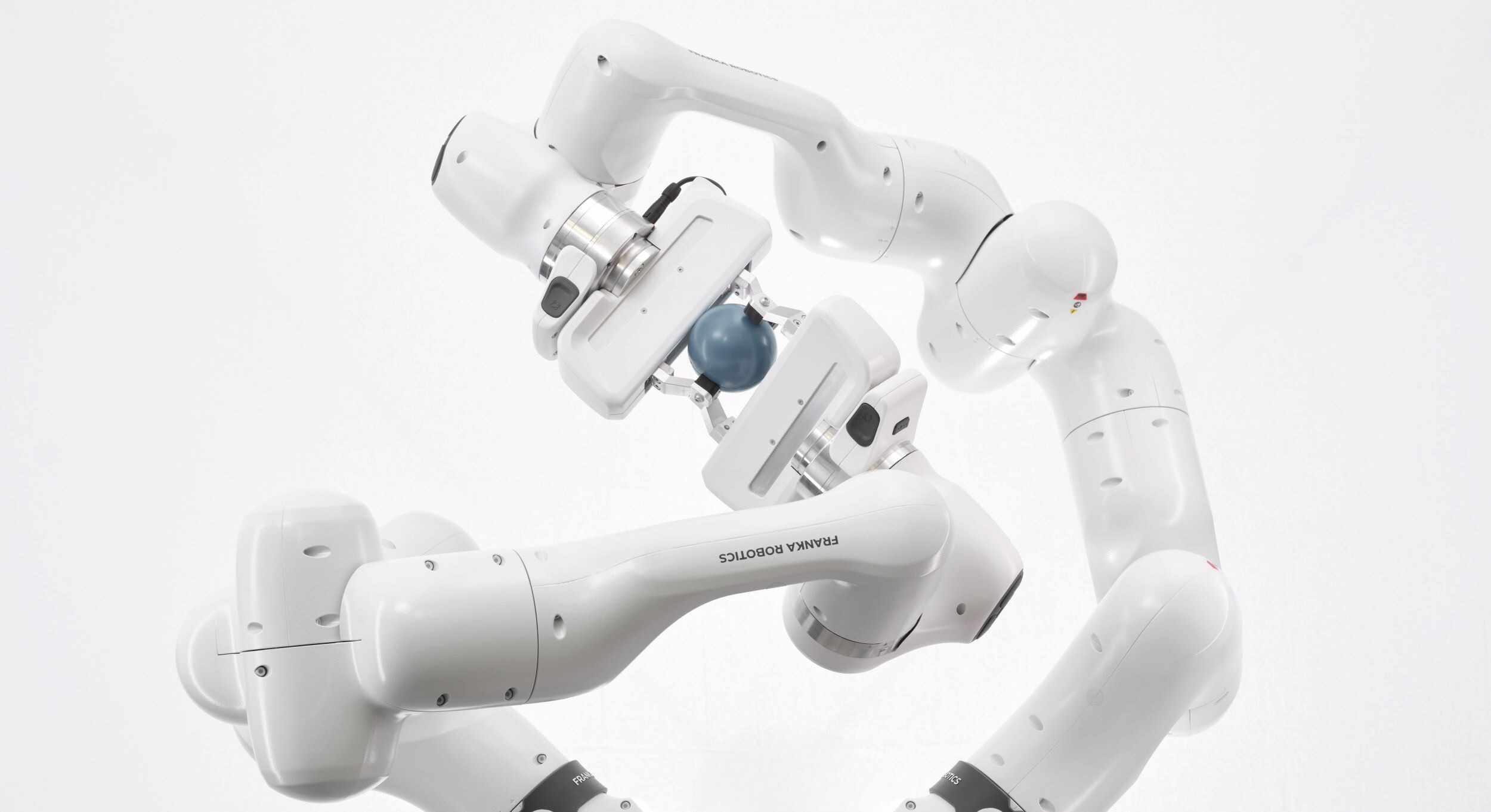 A white robot is standing in front of a black background