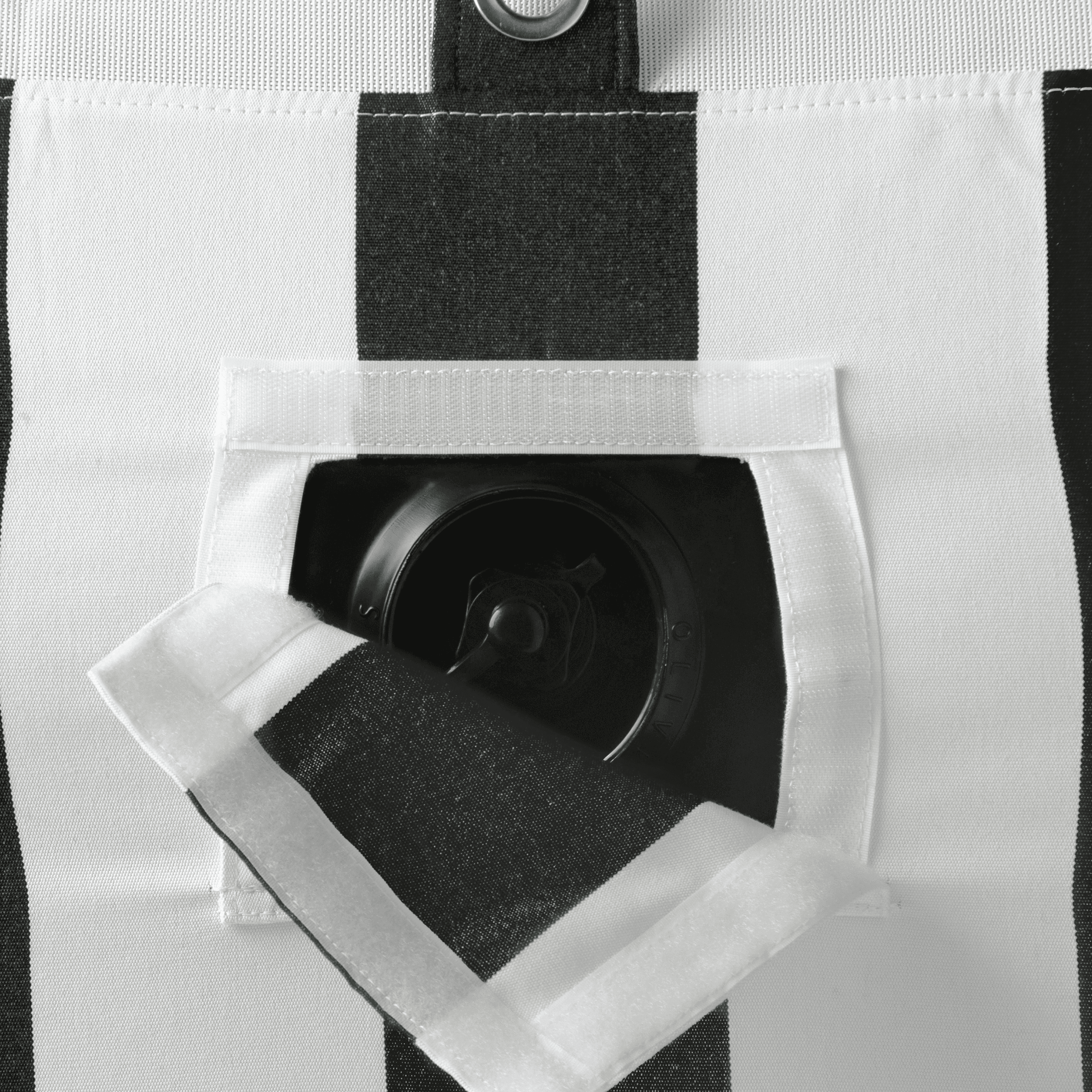 Close-up of pool float showing black-and-white canvas, inflation valve, and colour-matched zipper