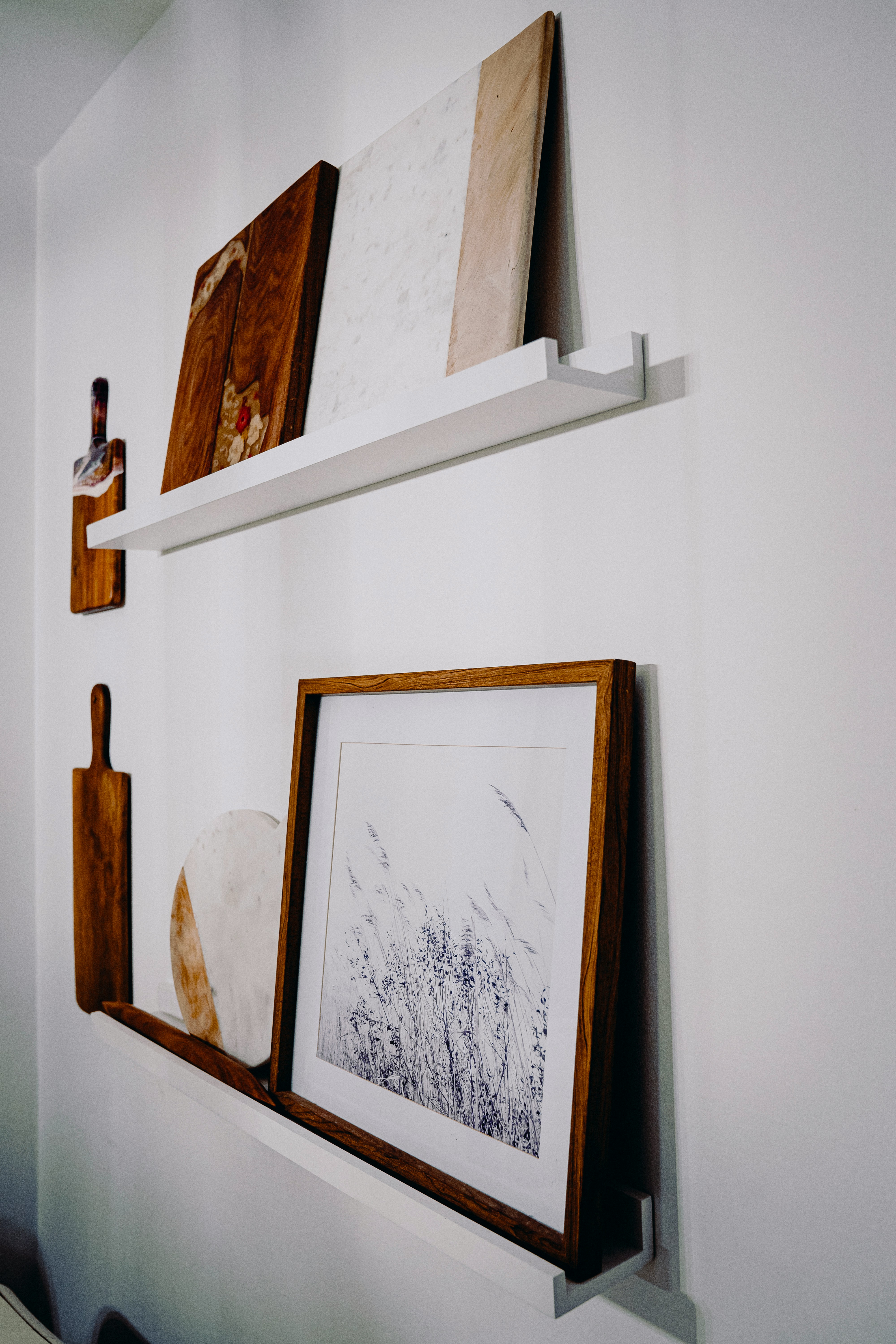 Modern indoor space with large glass doors, lush greenery, and a cozy seating area visible beyond.
