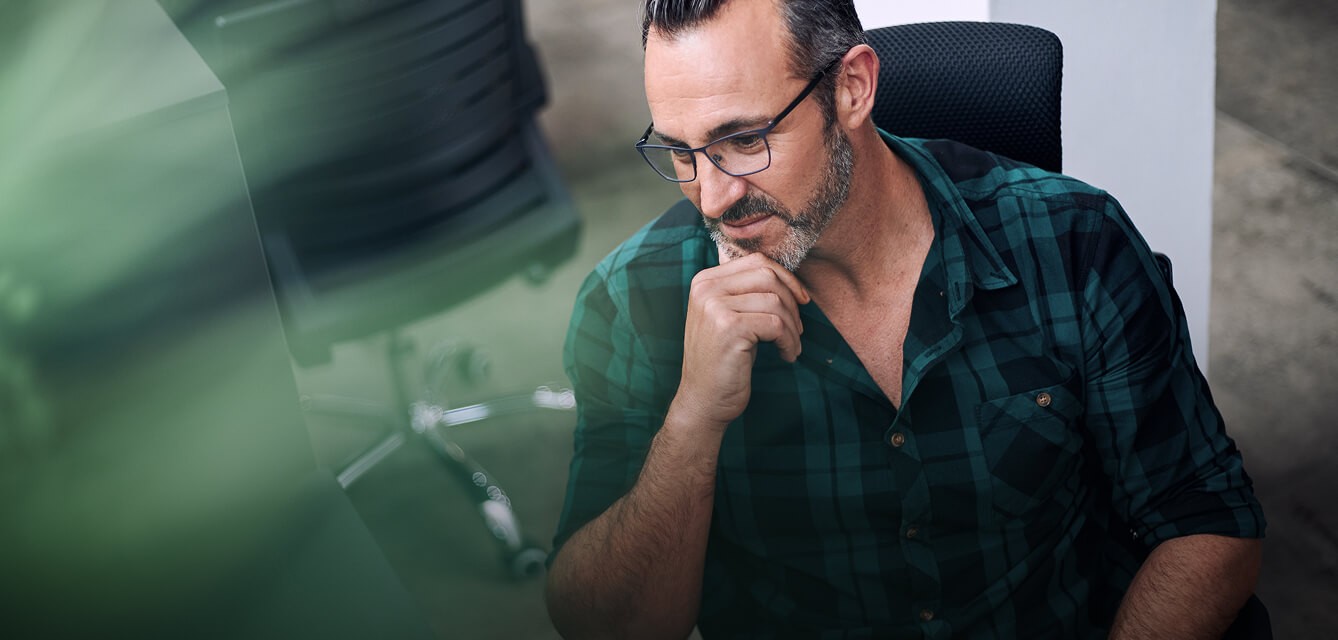 Middle aged man with glasses deep in thought
