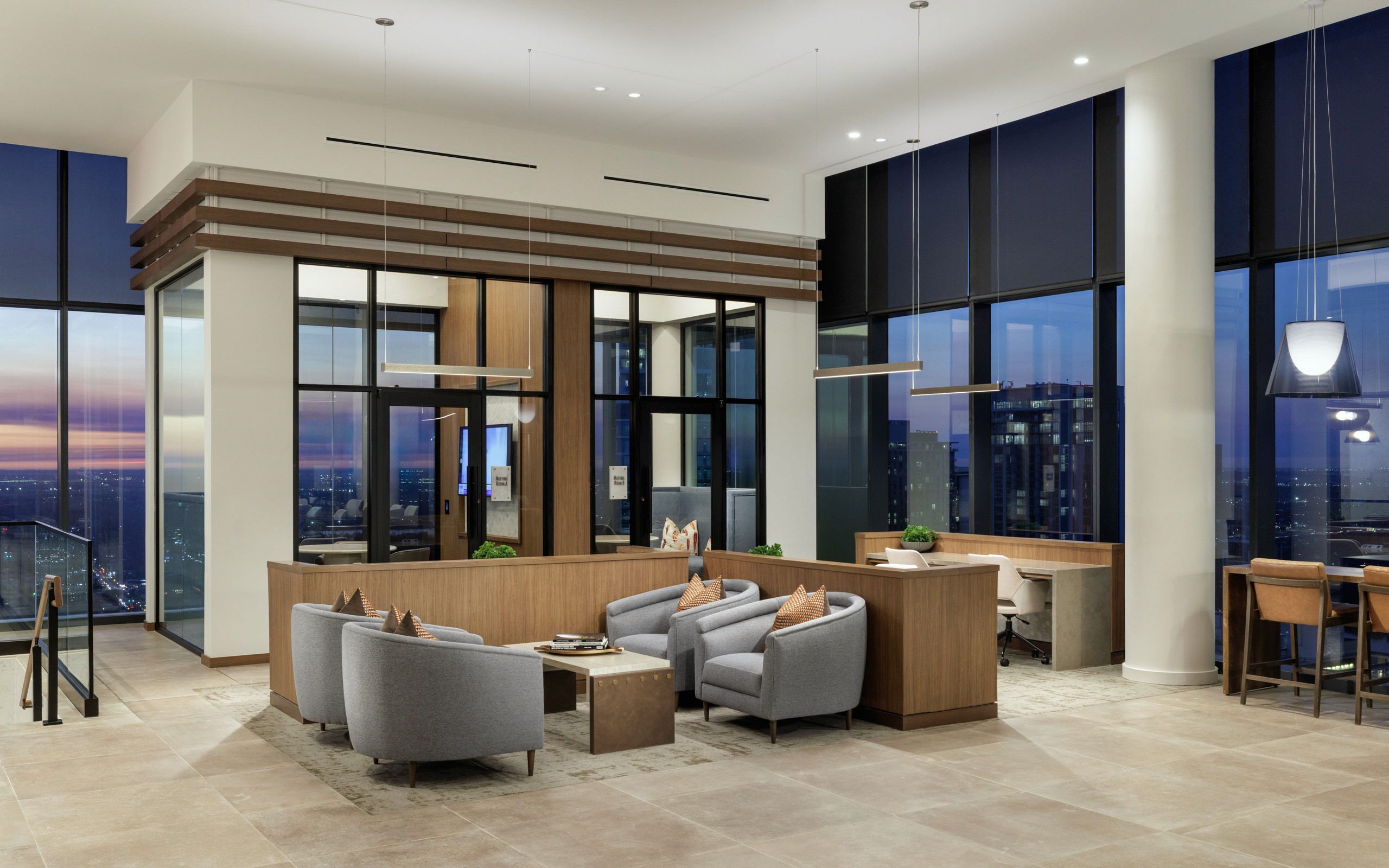 Modern lounge area with city view at dusk