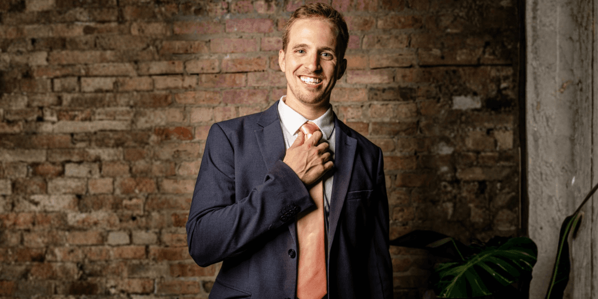Josh Meador, mentalist and event planner, dressed in a suit, smiling and engaging, ready to transform events into unforgettable experiences.