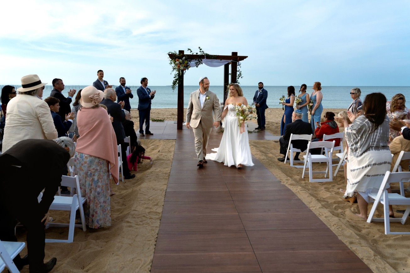 A couple in formal wedding attire embraces intimately in a vast.