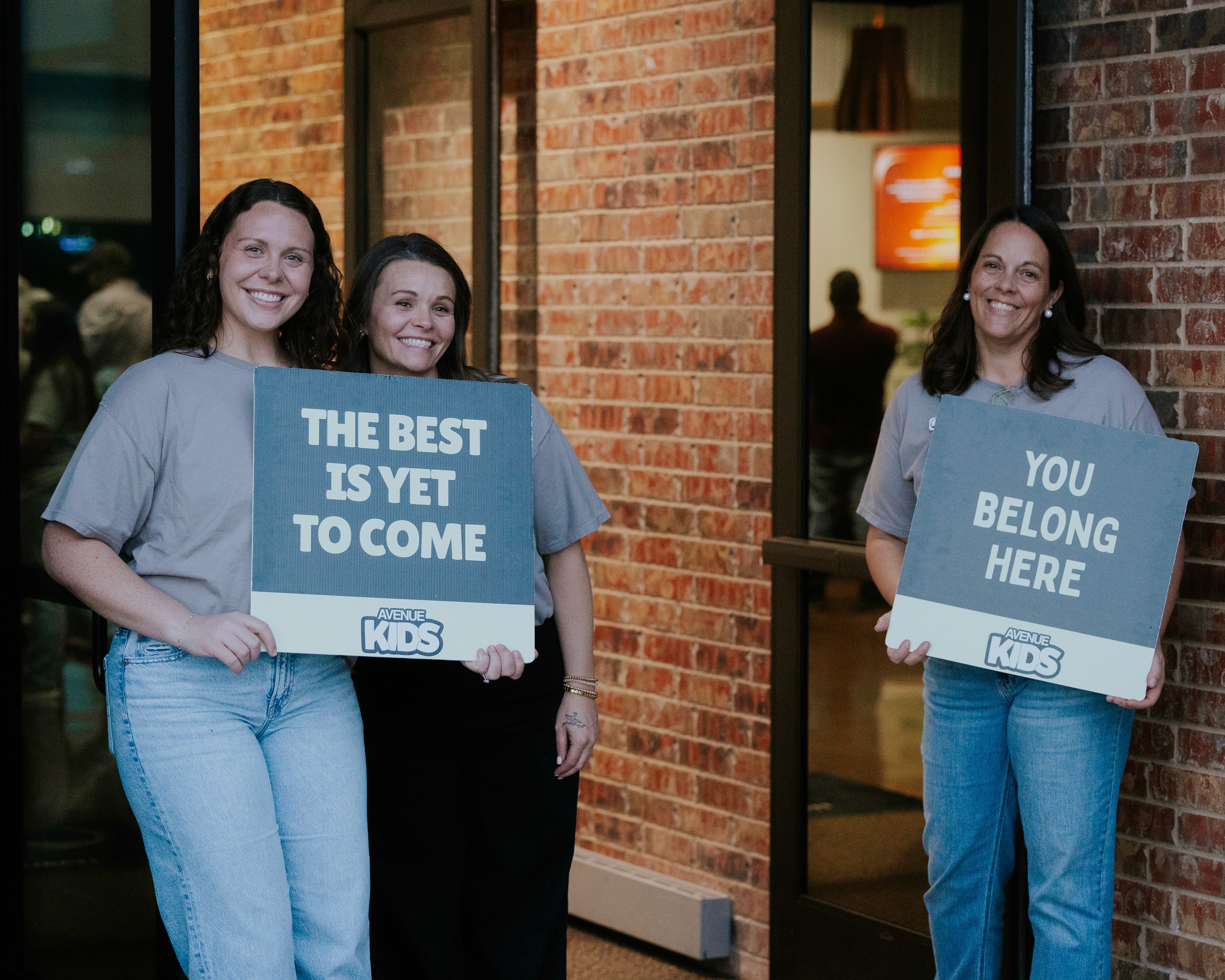 Two men engage in an arm wrestling match over a glistening surface, with one man cheering on the other.