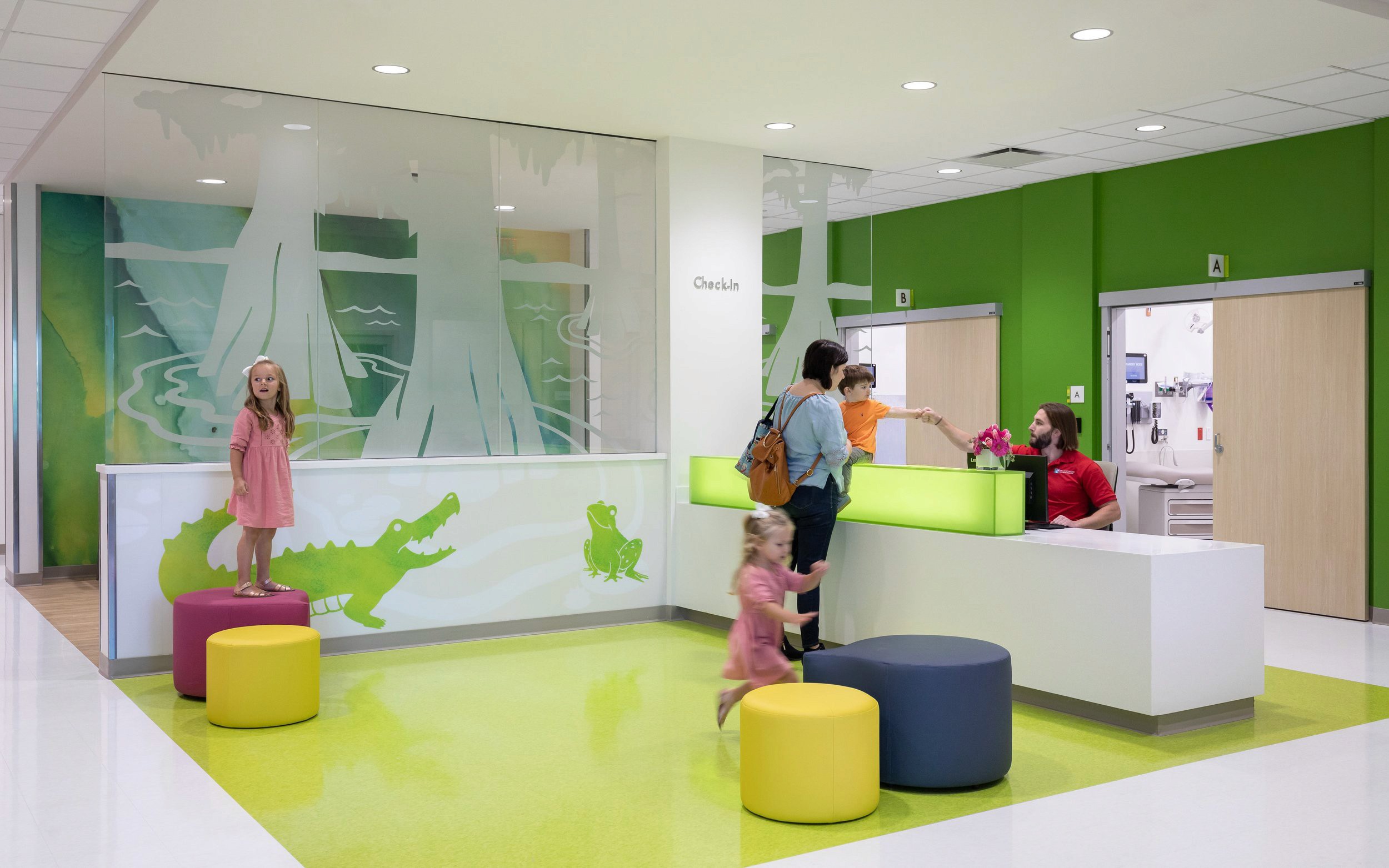 Children at a hospital check-in desk with playful decor