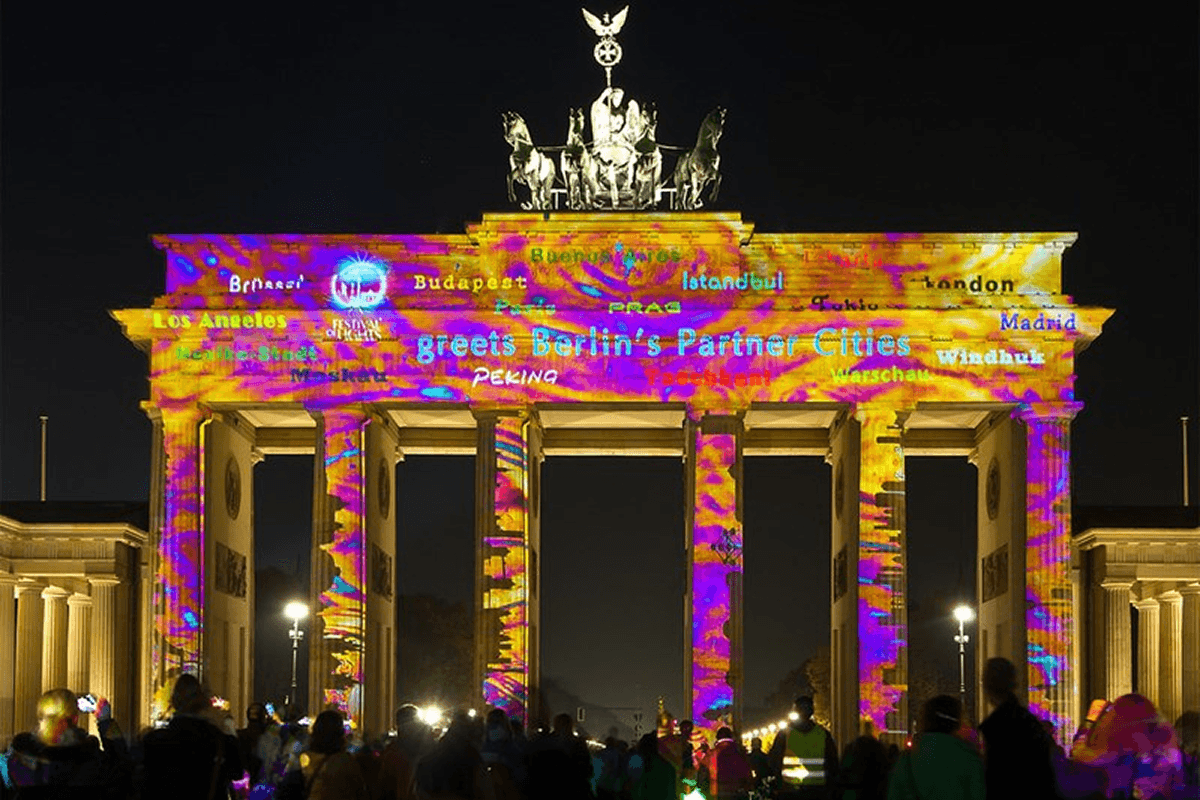 Brandenburg Gate in Berlin illuminated with colourful light projections at night