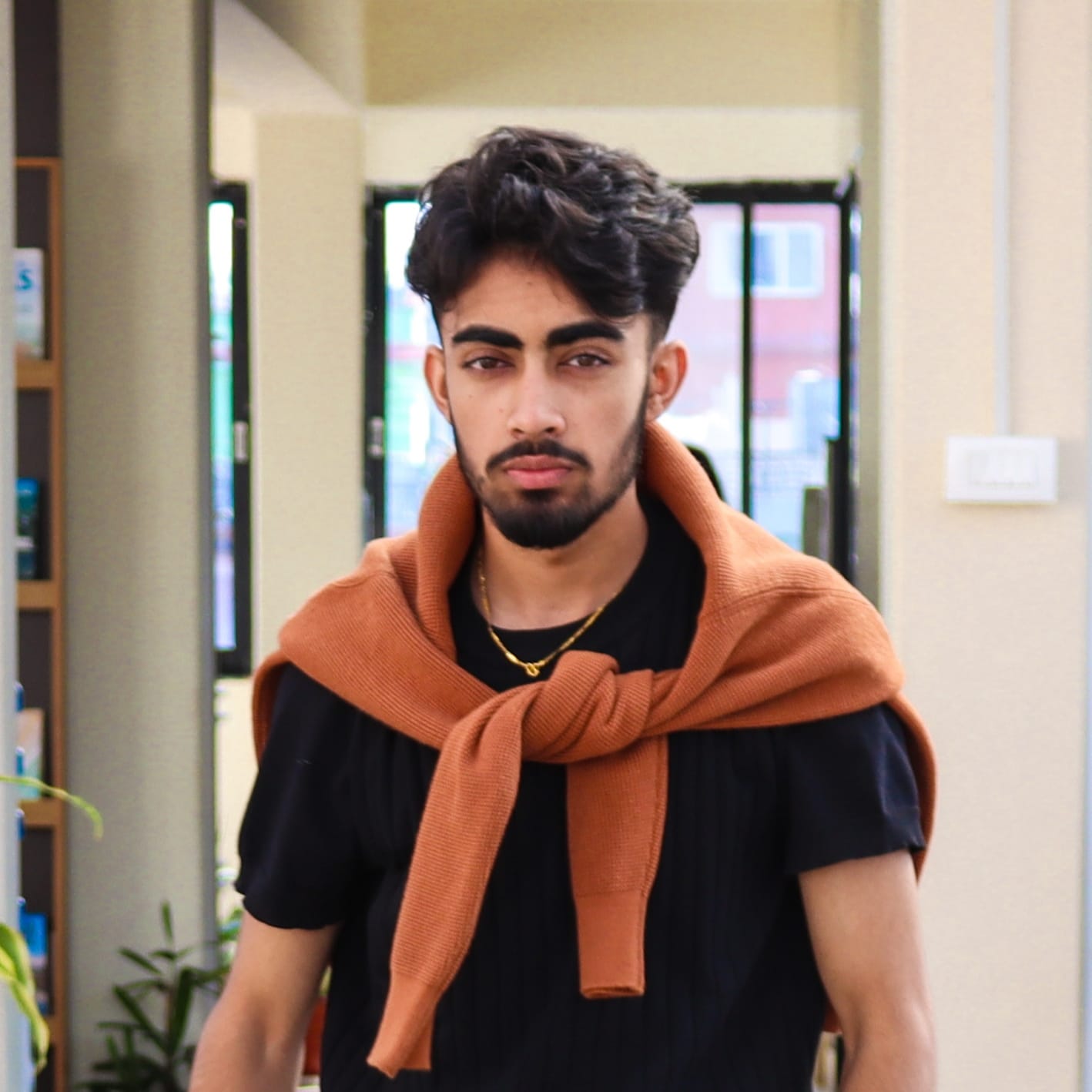 A professional headshot of Nischal Poudel walking towards the camera