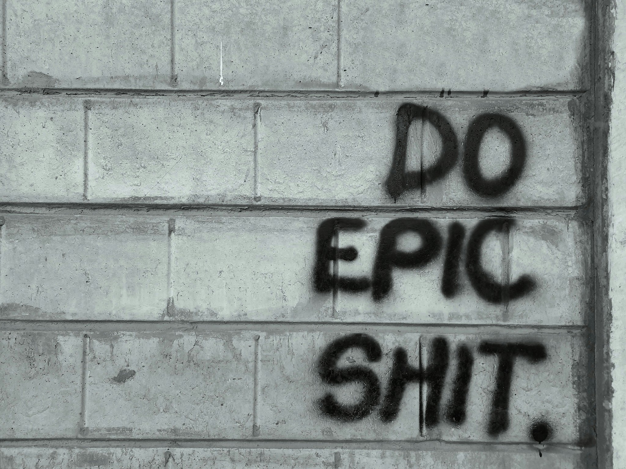 graffiti written on a wall that says do epic shit