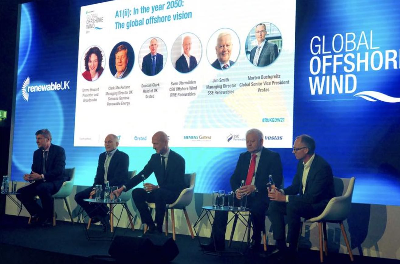 Panel of speakers seated on stage at a Global Offshore Wind conference event.