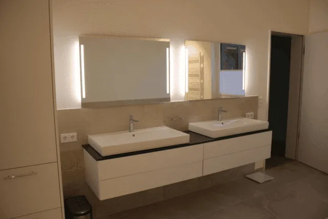 a white cupboard built in the bathroom.