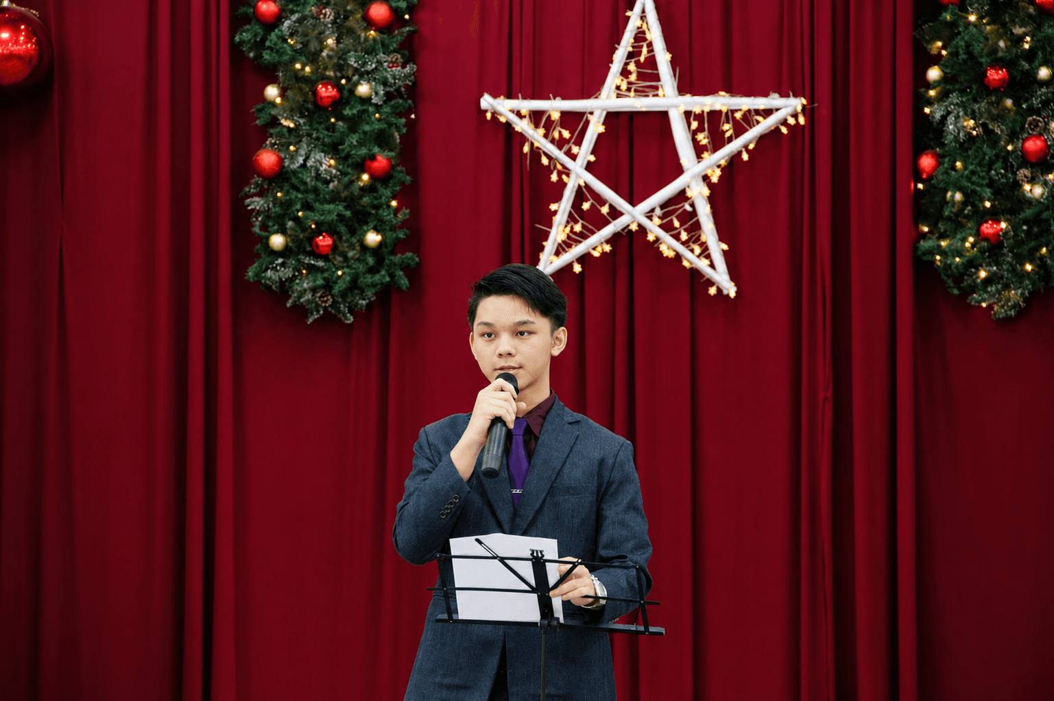 Elpis International School student giving a presentation on stage in Yangon, Myanmar