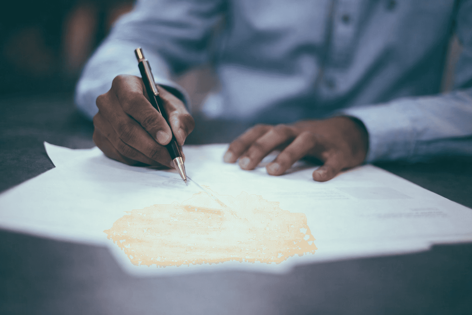 man writing on paper