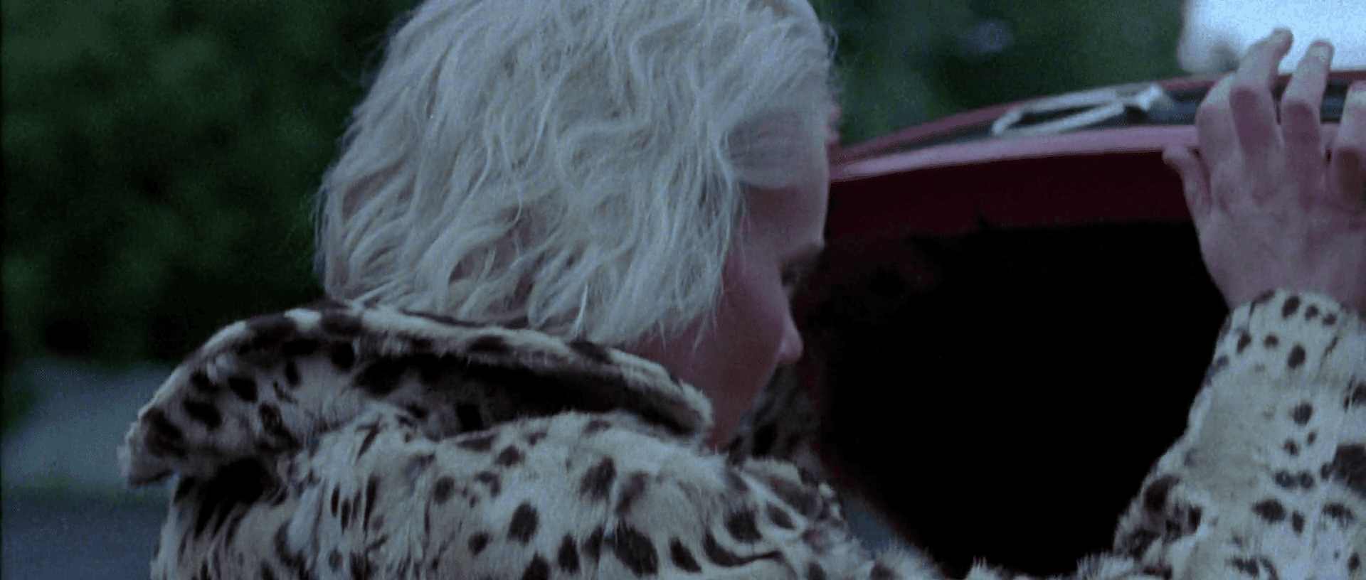 Lush green conical mountains under a hazy sky