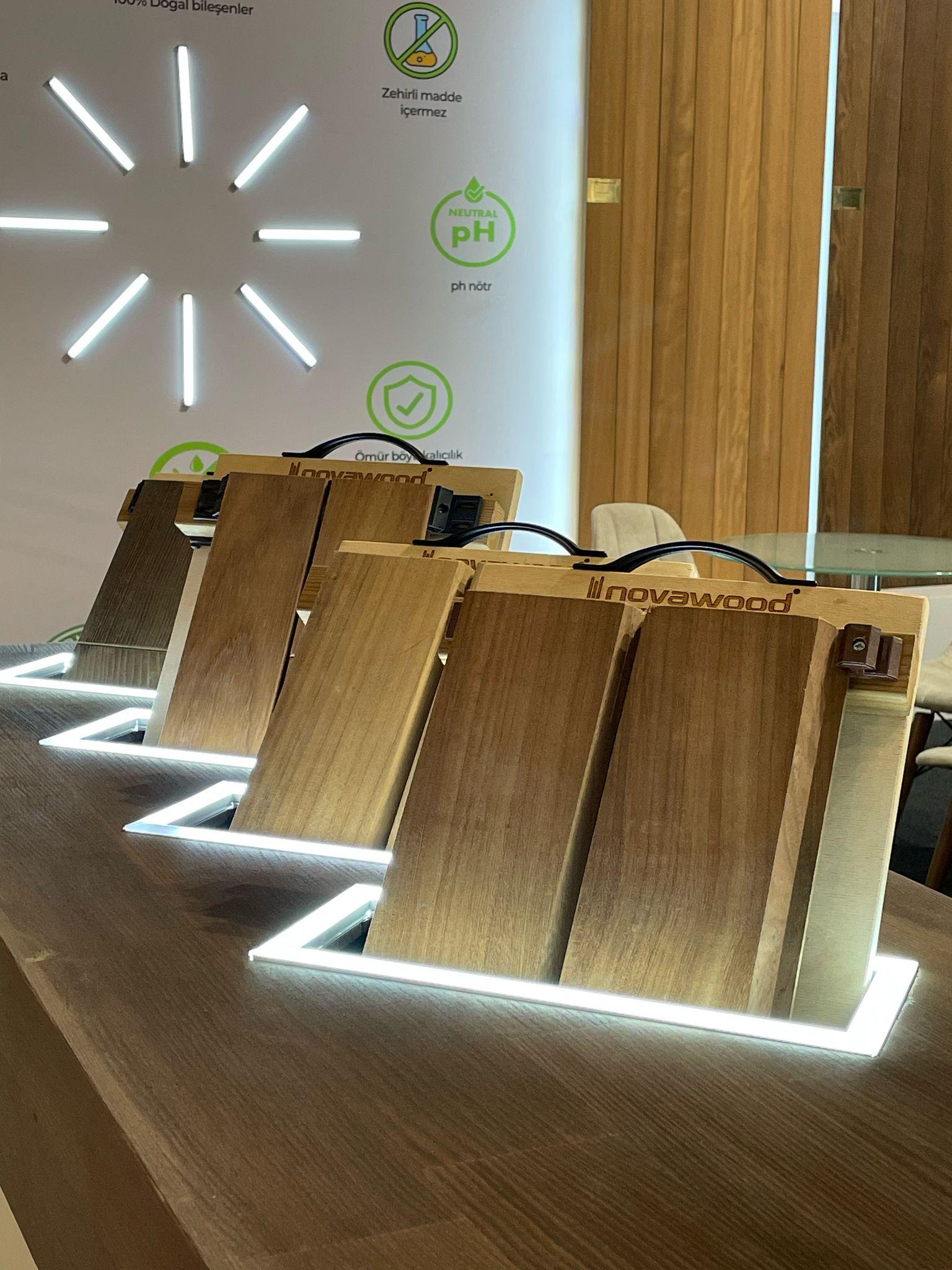 Product sample displays within the Novawood stand, showcasing Thermowood, decking, and cladding materials.