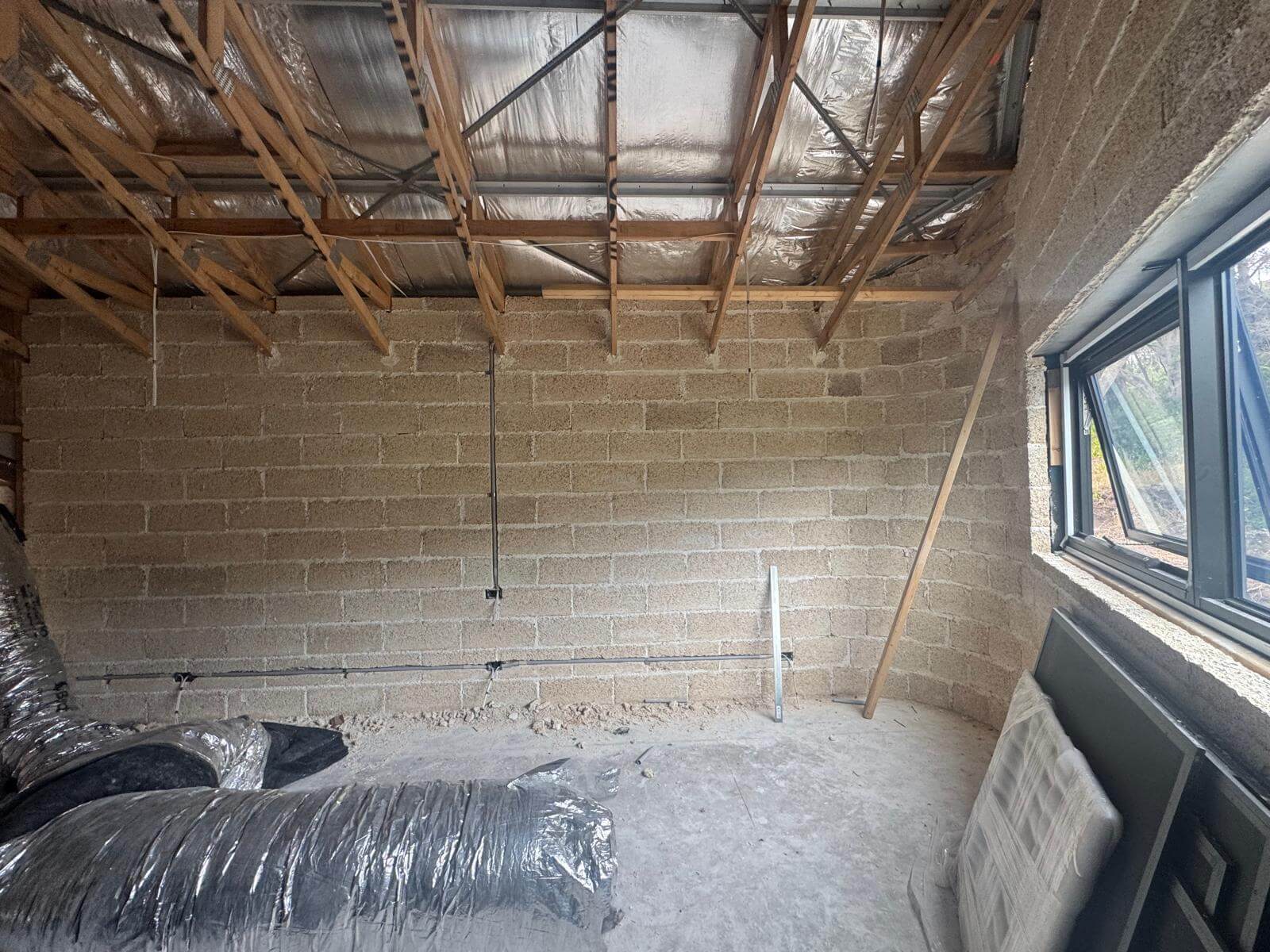 Hempcrete Block Image showing a hemp block wall in a shed house