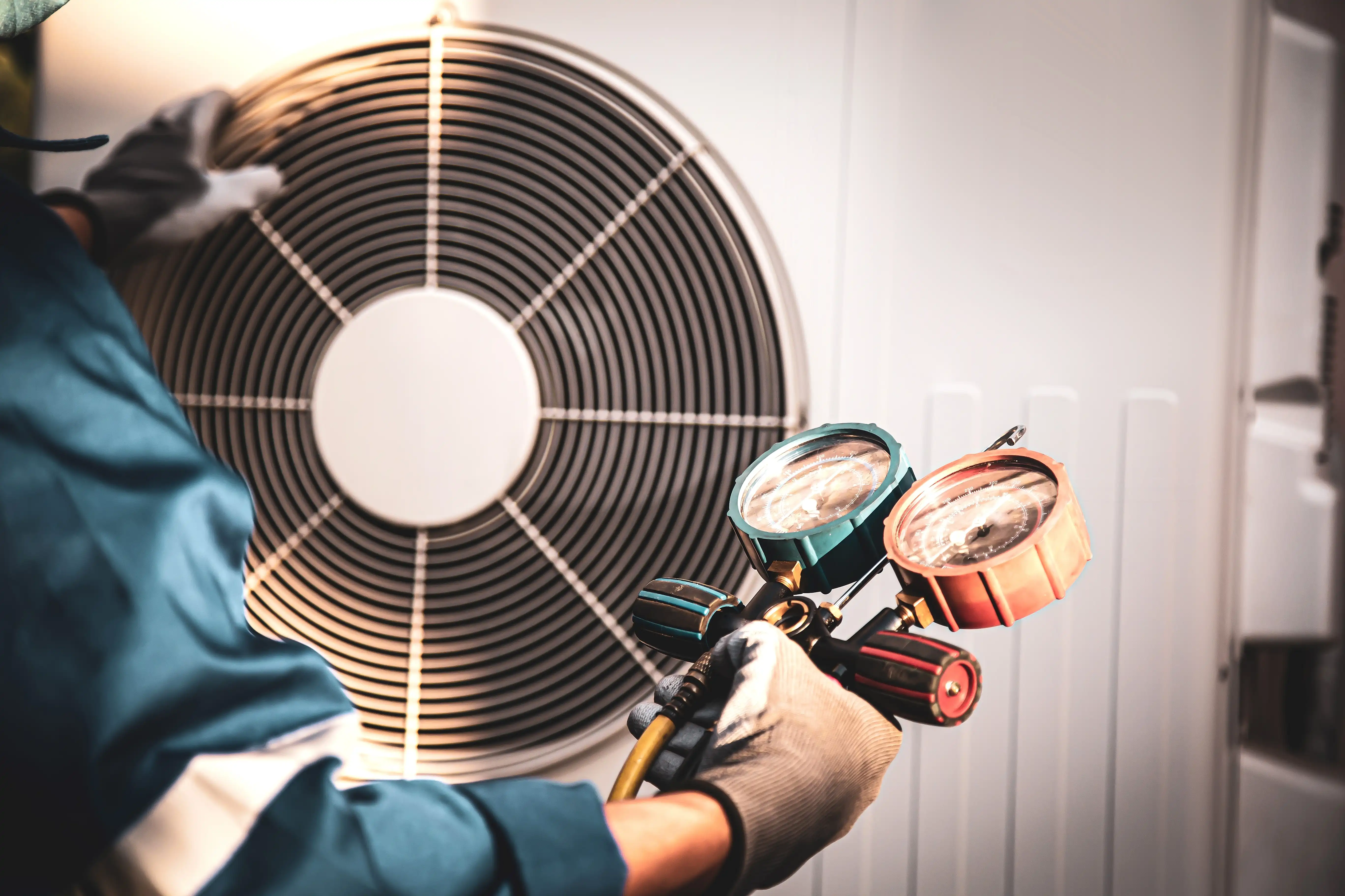 Worker checking HVAC exterior unit