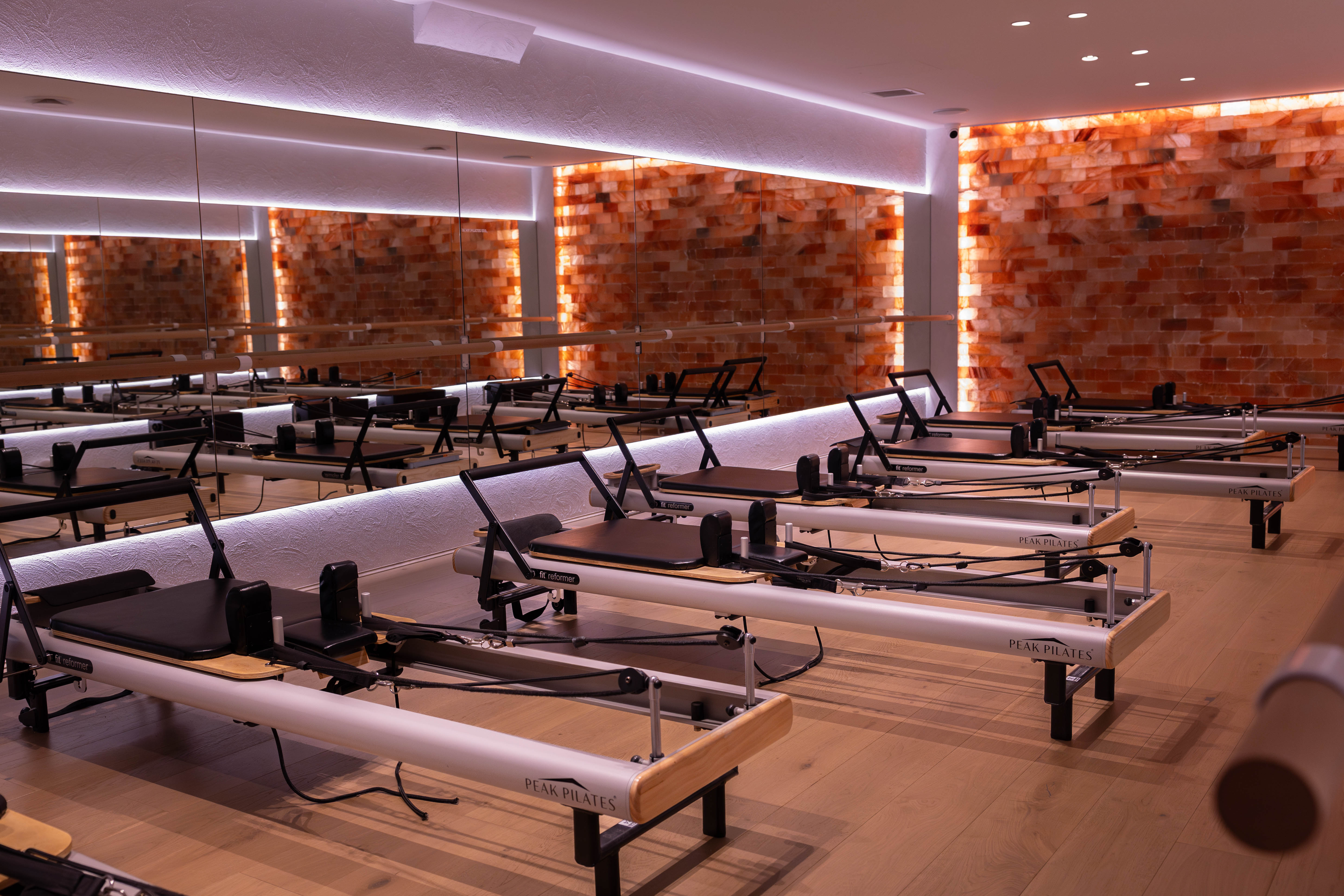 Rachel, personal trainer, looking to the side confidently in a fitness studio