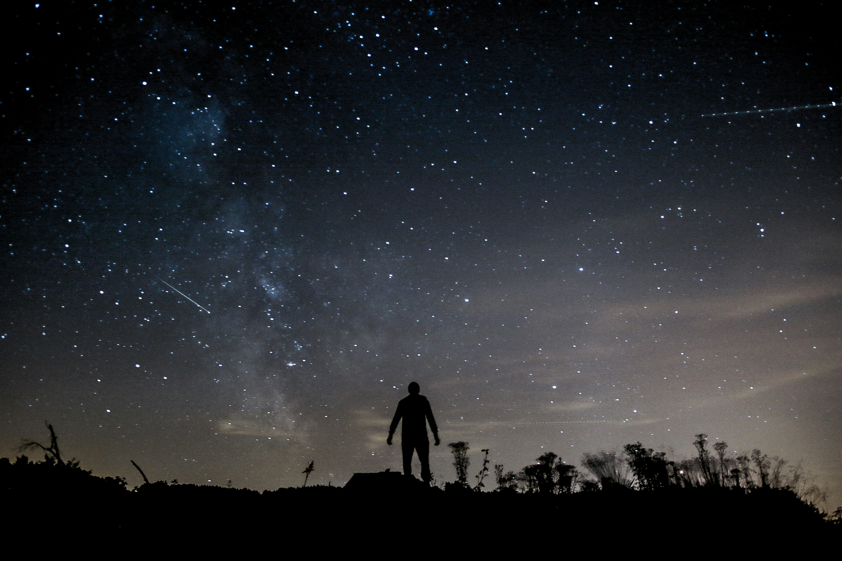 A person staring at the Milky Way at night.