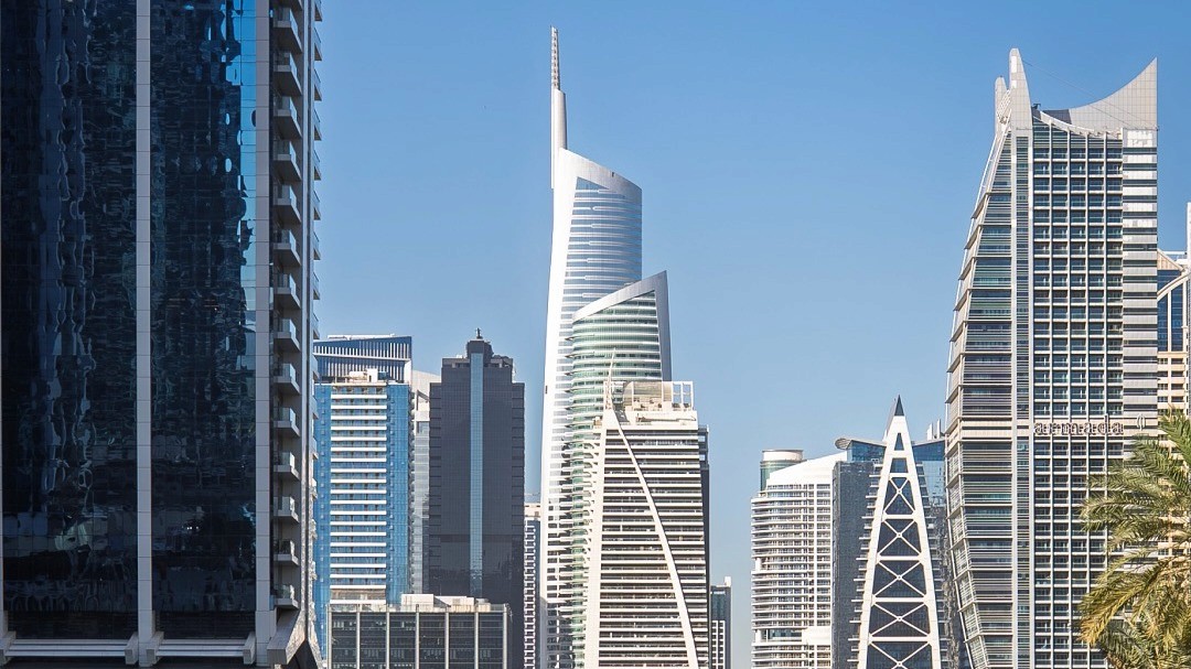 An image of Jumeirah Lake Towers community with skyscrapers and the bright blue sky. 