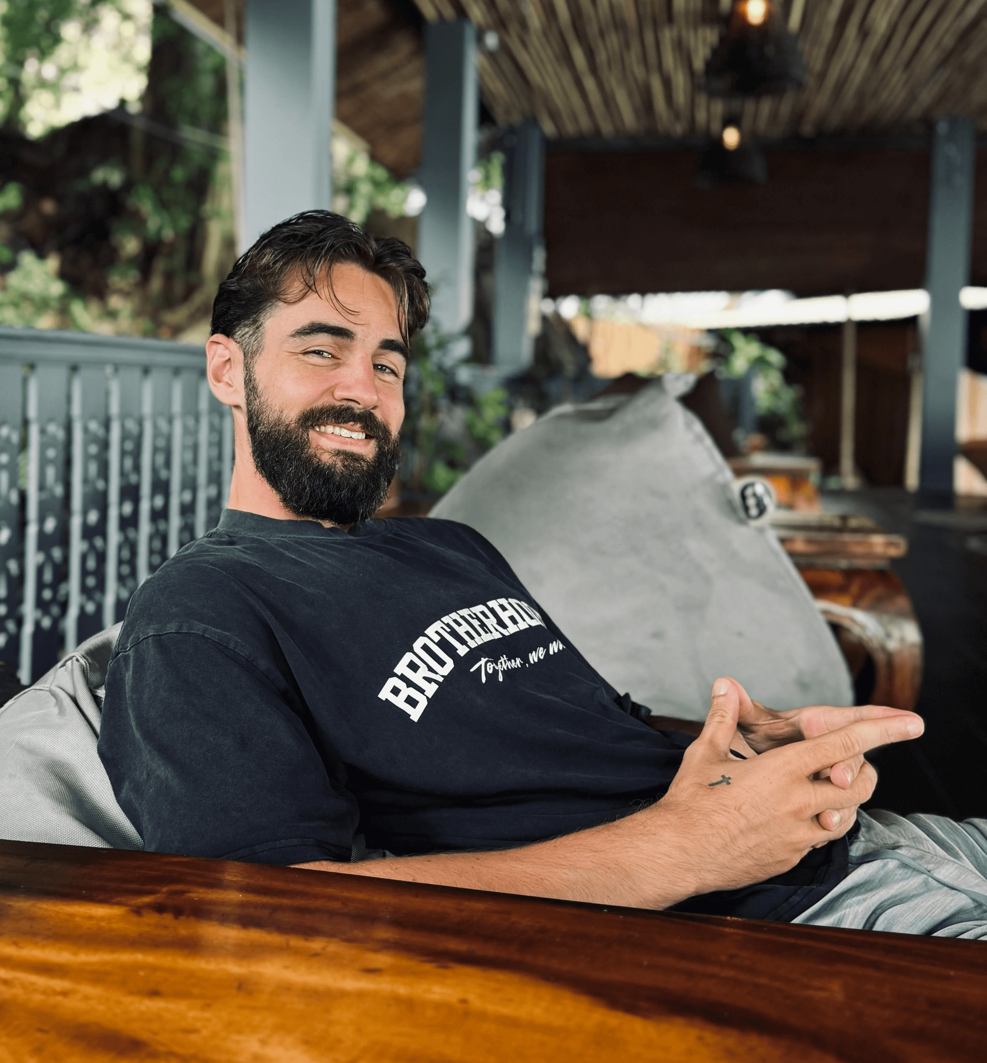 Professional headshot of a business advisor in a white shirt, smiling confidently against a warm neutral background.