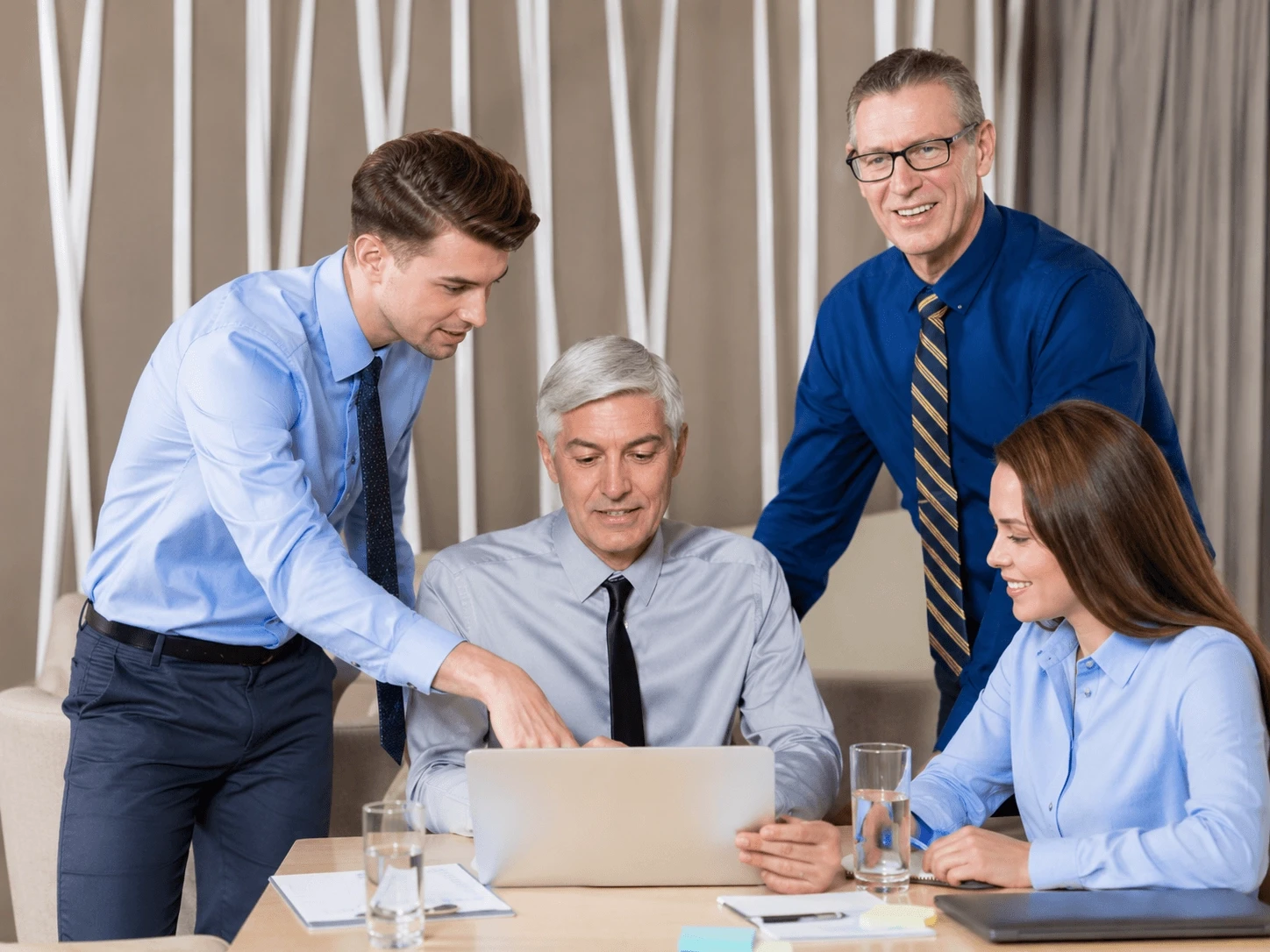 Real estate professionals reviewing payment data and financial operations using automated payment software.