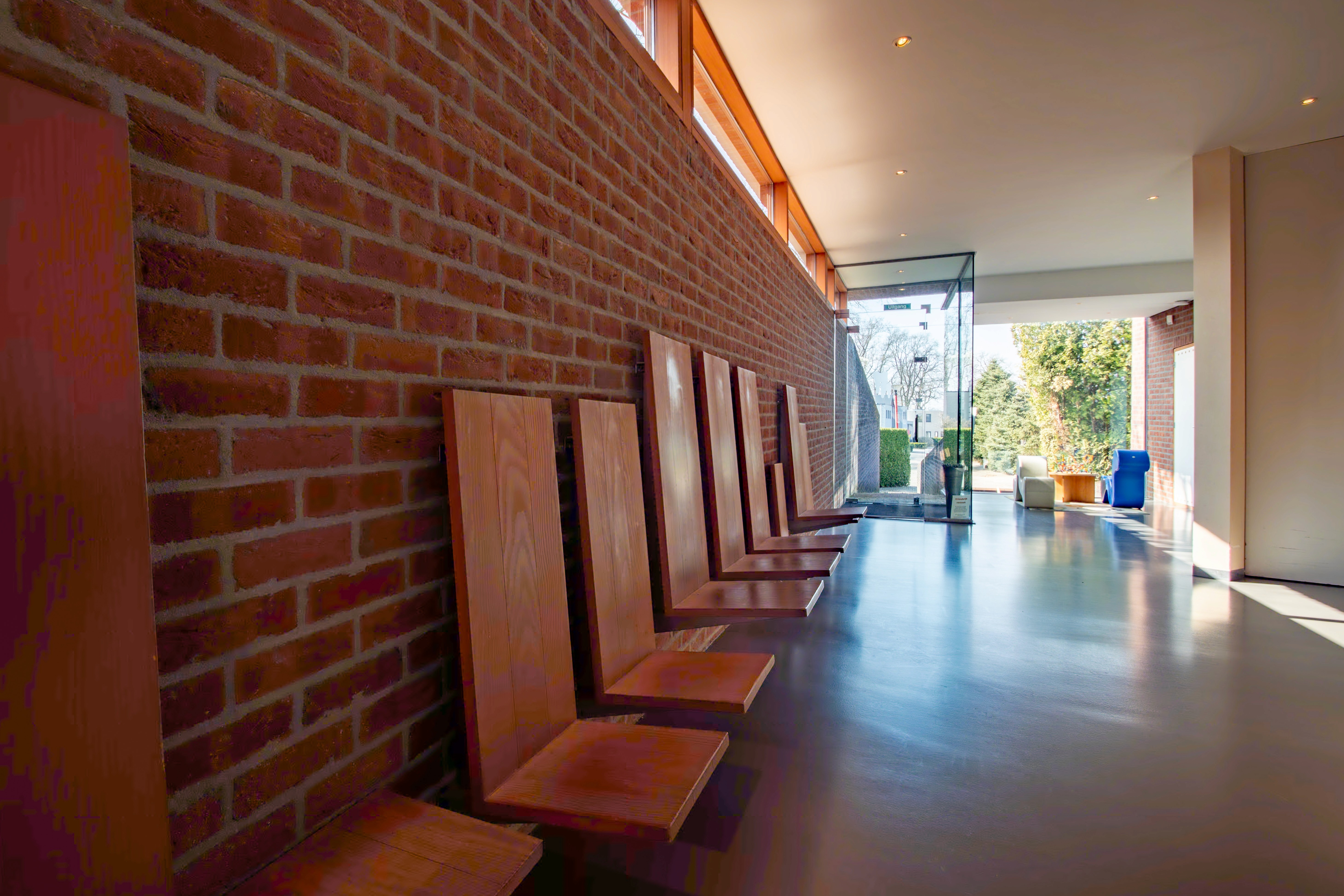 Modern kitchen interior featuring a central island, wooden cabinetry, and bright lighting. Spacious and minimalist design.