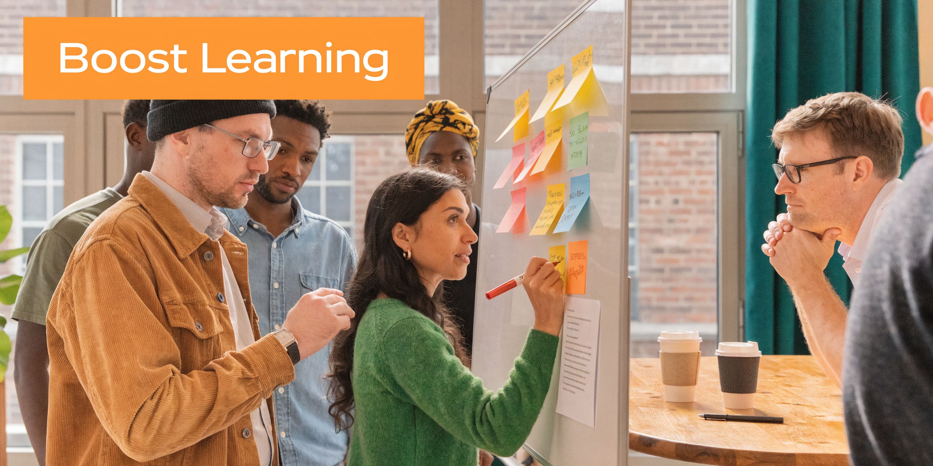 A diverse team of professionals brainstorming ideas using sticky notes on a whiteboard in an office setting.