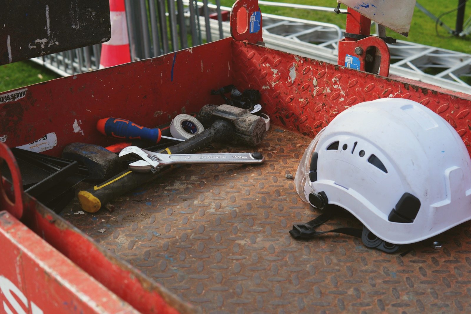 Tools and a hard hat in the back of a work truck