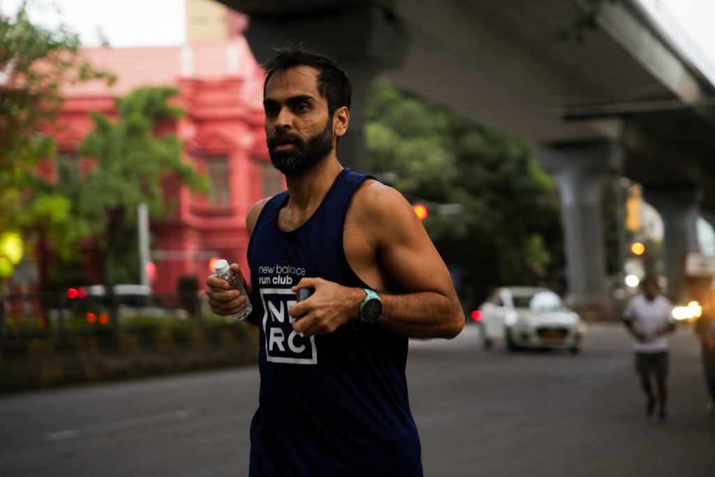 Shirtless man meditating indoors