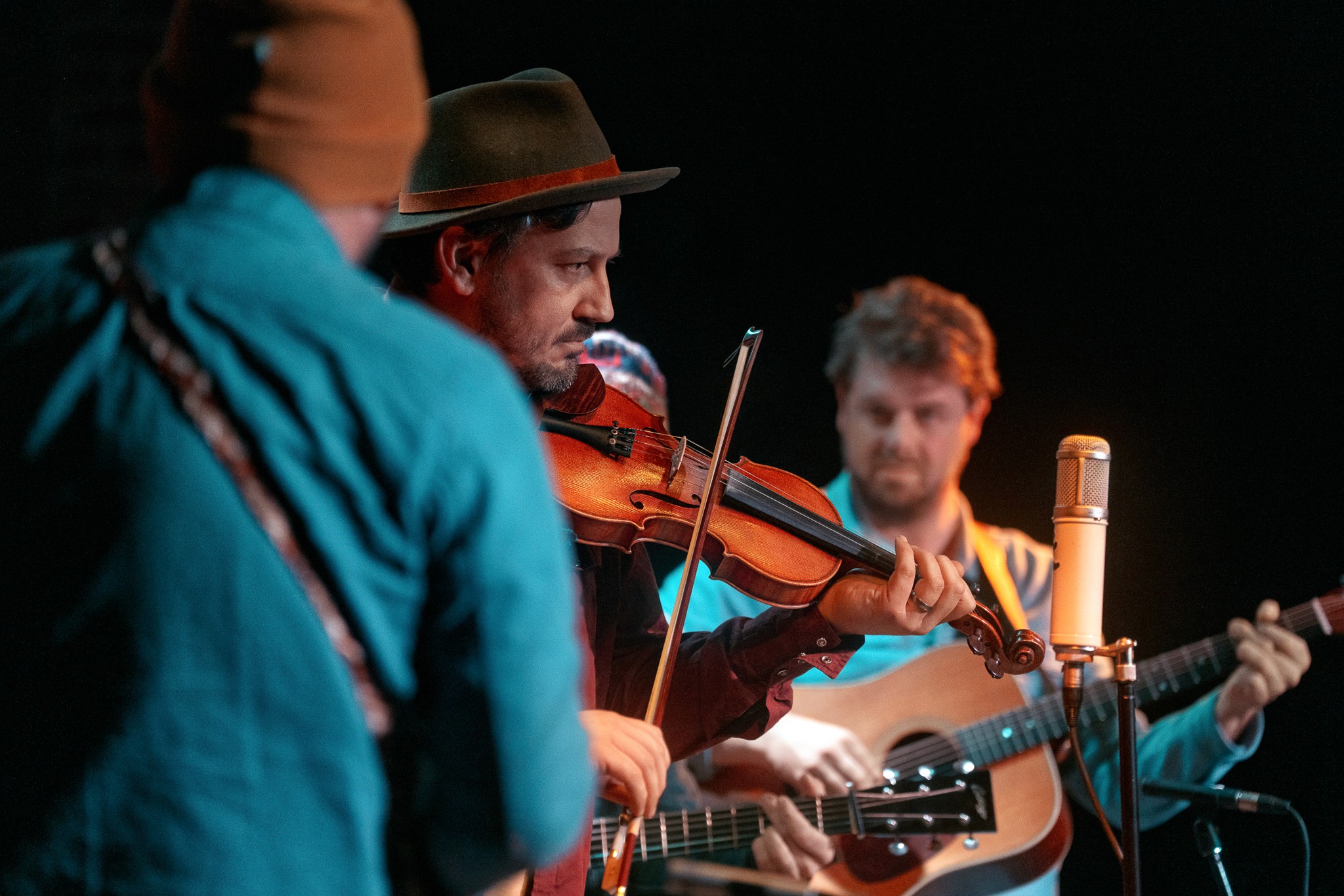 Group of men playing folk music on stage
