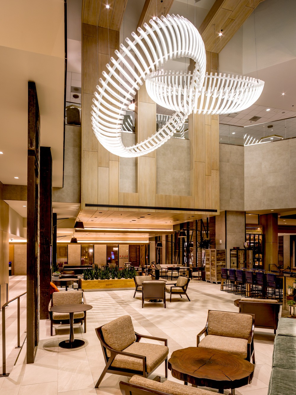 Finale lighting installation suspended in Marriott's Innovation Lab, featuring hand-blown fluted glass elements forming a dynamic centerpiece