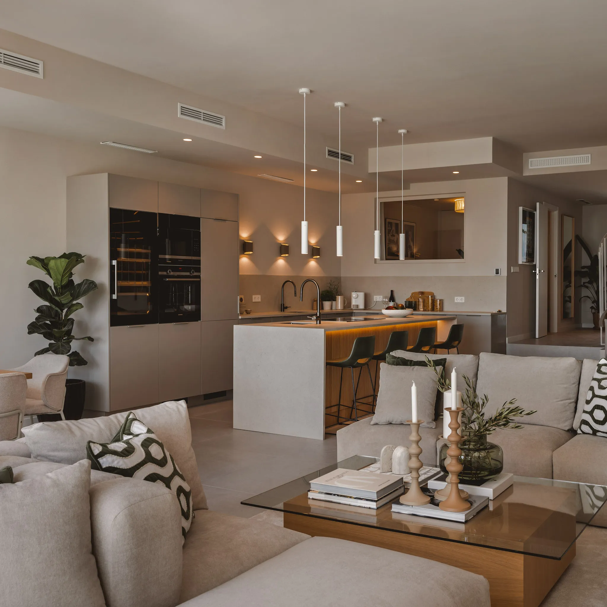 Open-plan kitchen and living area at La Quinta Townhouse with warm neutral interiors