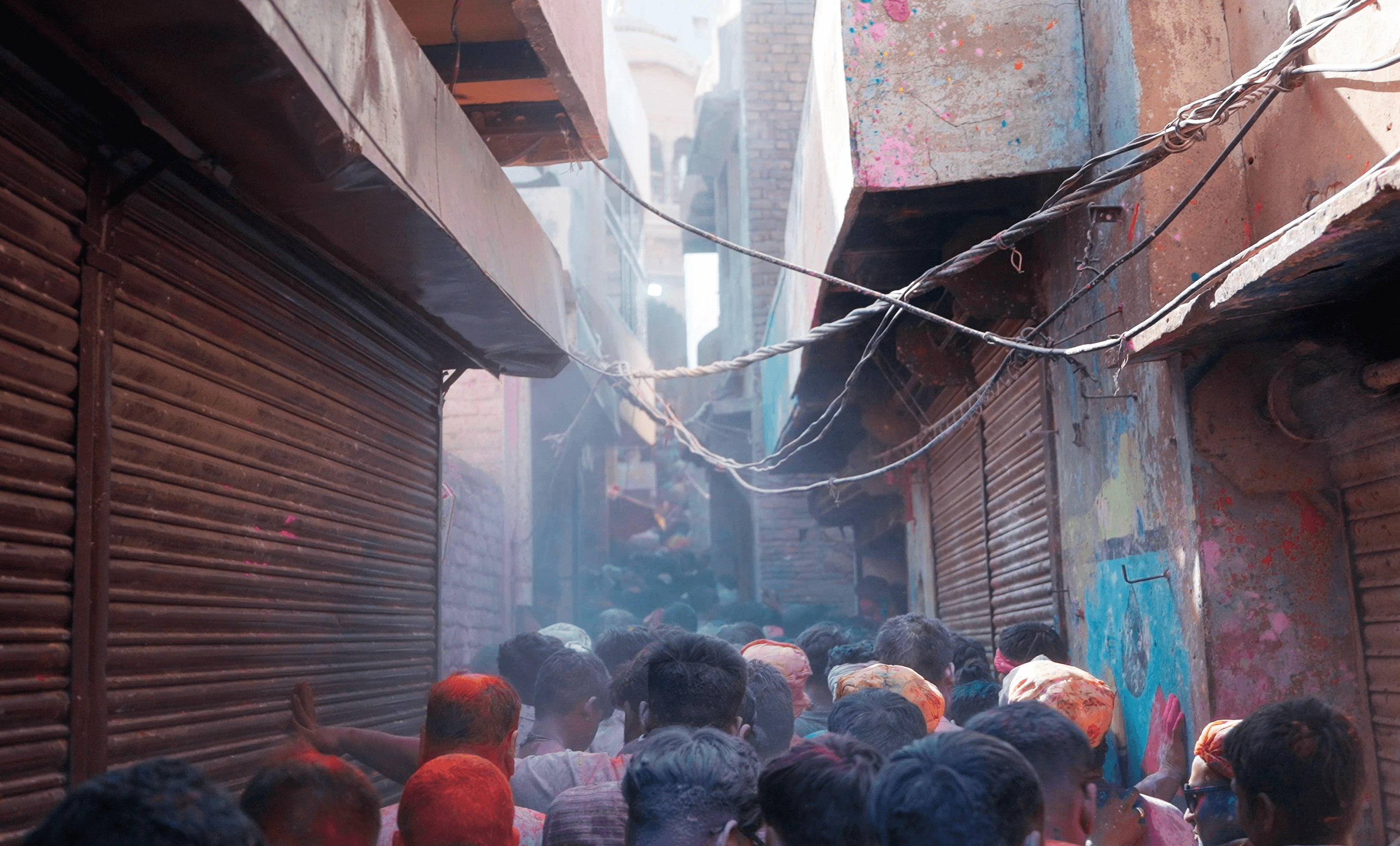 Drone view of the temple and thousands of people covered in colored powder
