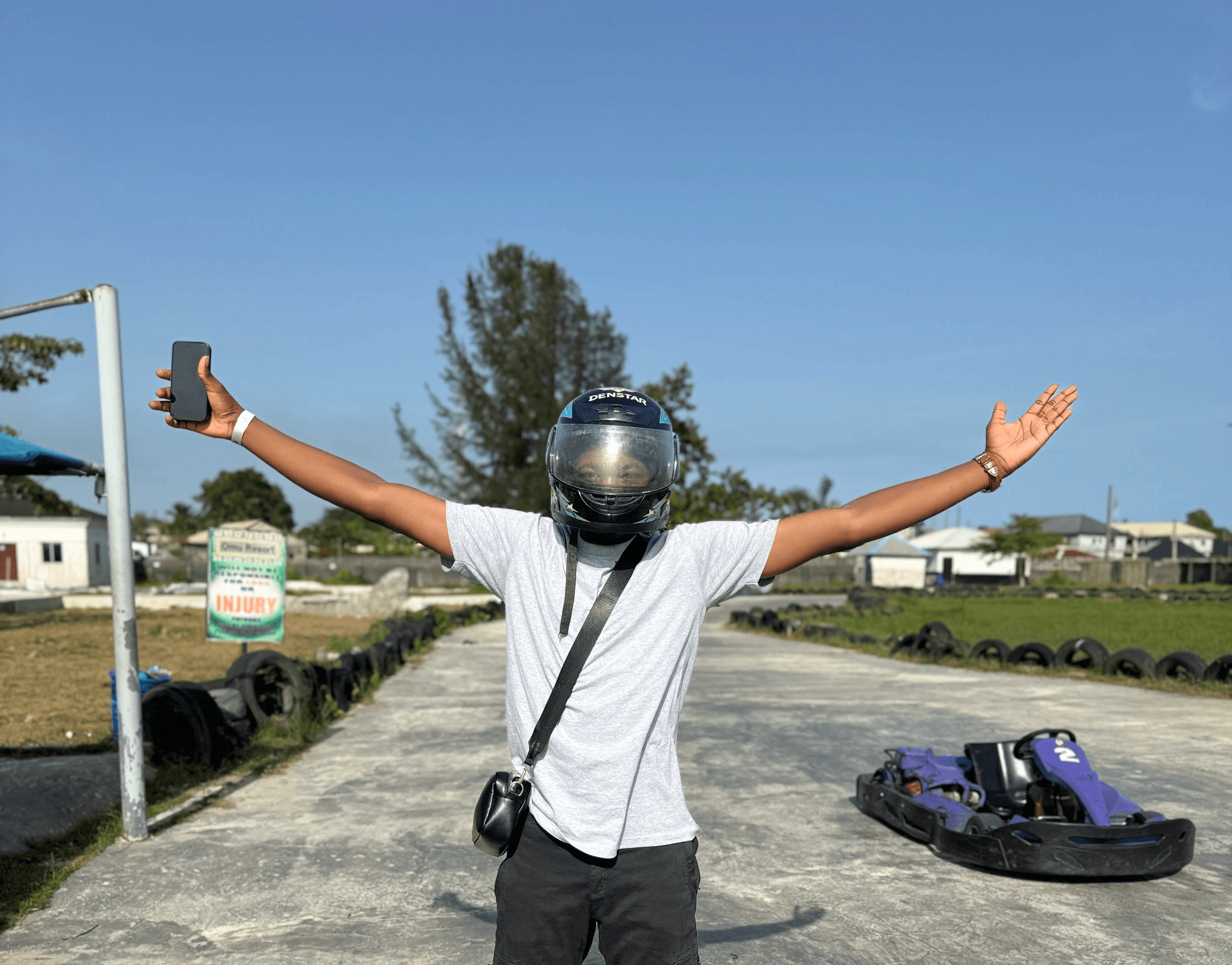 Close-up of a yellow tennis ball sitting on a green court, positioned near the white center line.