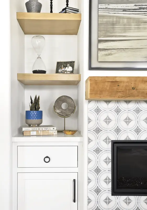 Portrait image focusing on the living room cabinet and fireplace details, accentuating the design and functionality in the Dana Point Remodel. Photo by Todd Huge.