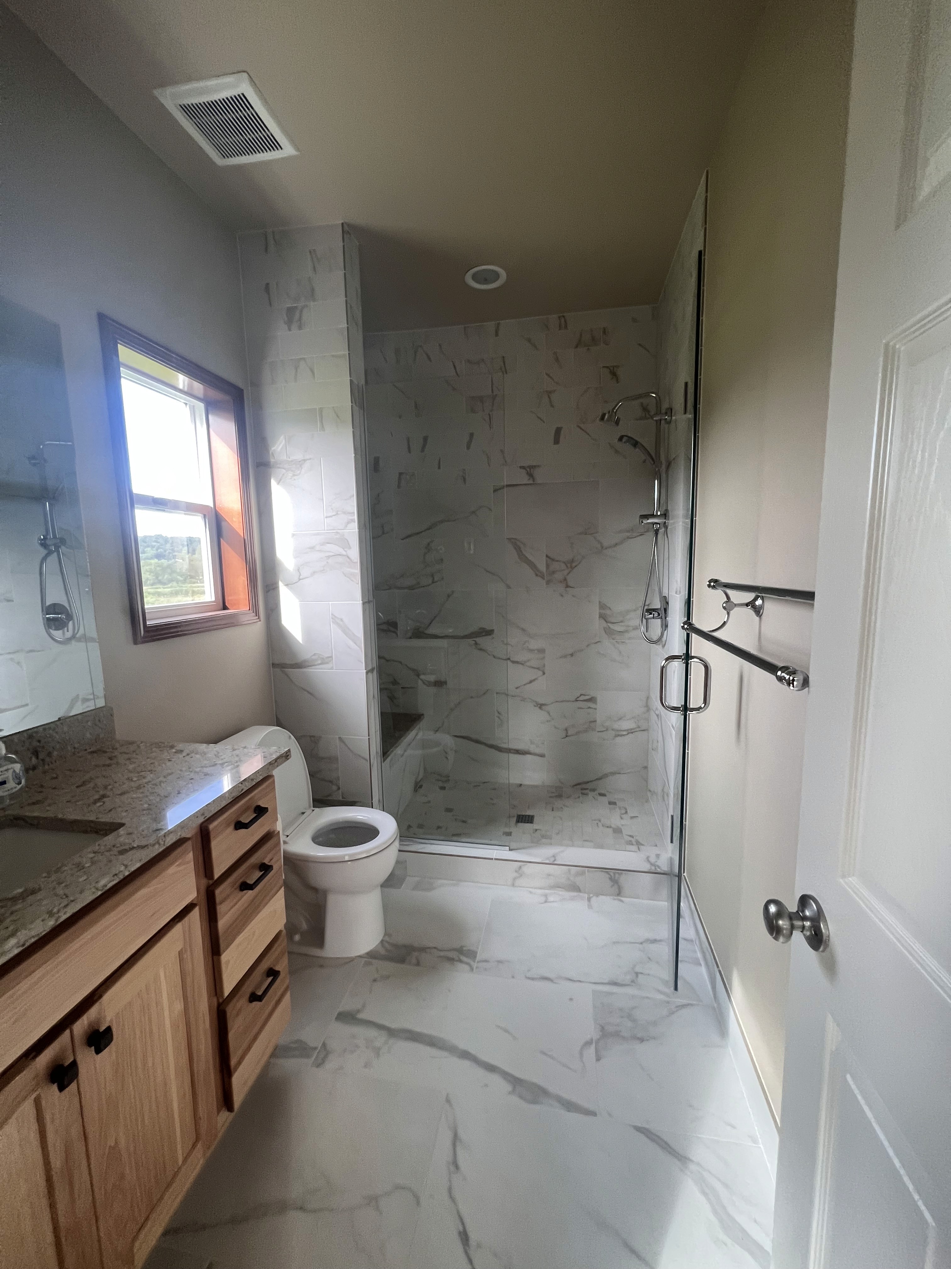 Modern loft interior with greenery, exposed brick walls, large glass windows, and vibrant yellow accents. Inviting atmosphere with natural light.