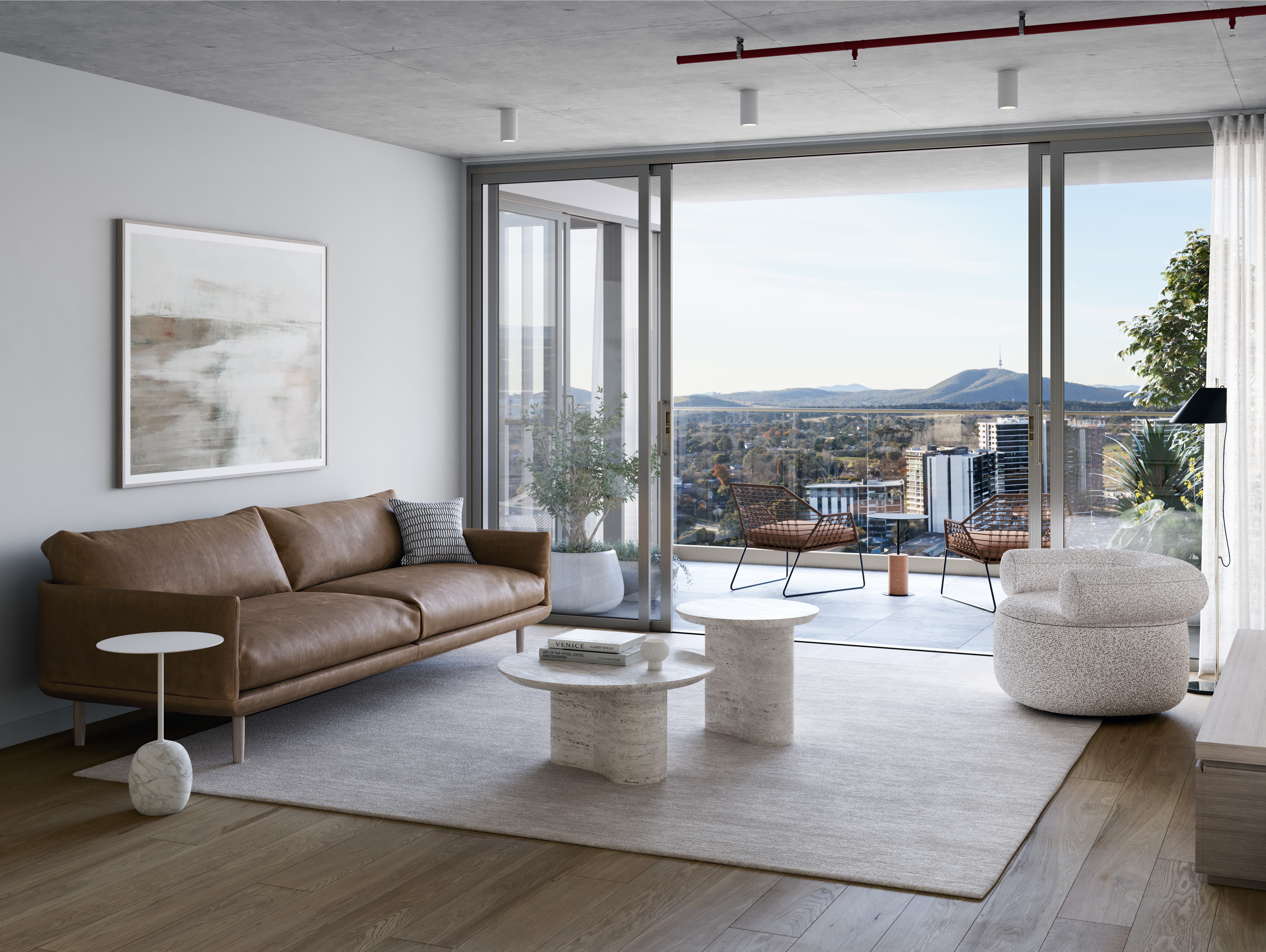 Modern living room at The Charlotte Woden featuring a leather sofa, soft neutral decor and a balcony overlooking Canberra, available to secure with Coposit.