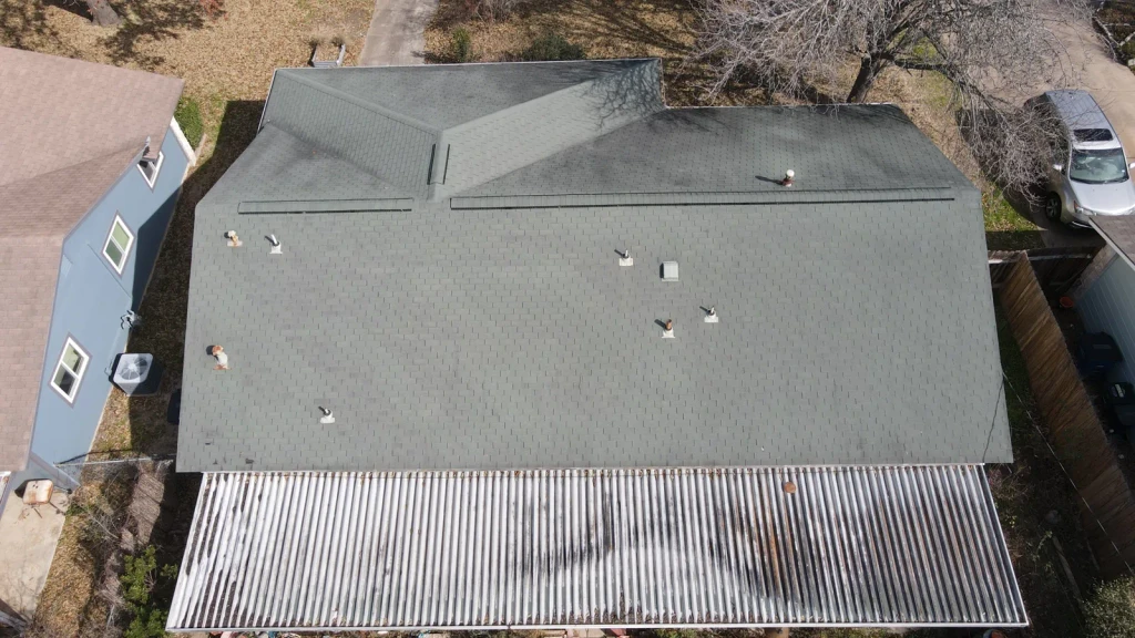 Before: Austin Shingle Roof Replacement Above a Covered Patio.